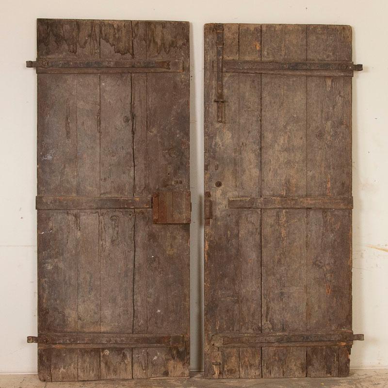Using old barn doors as unique interior sliding doors is a popular style element in homes today. This pair of 7' architectural antique doors have the severe weathered, aged appeal that will be a perfect addition with true vintage appeal. The deep