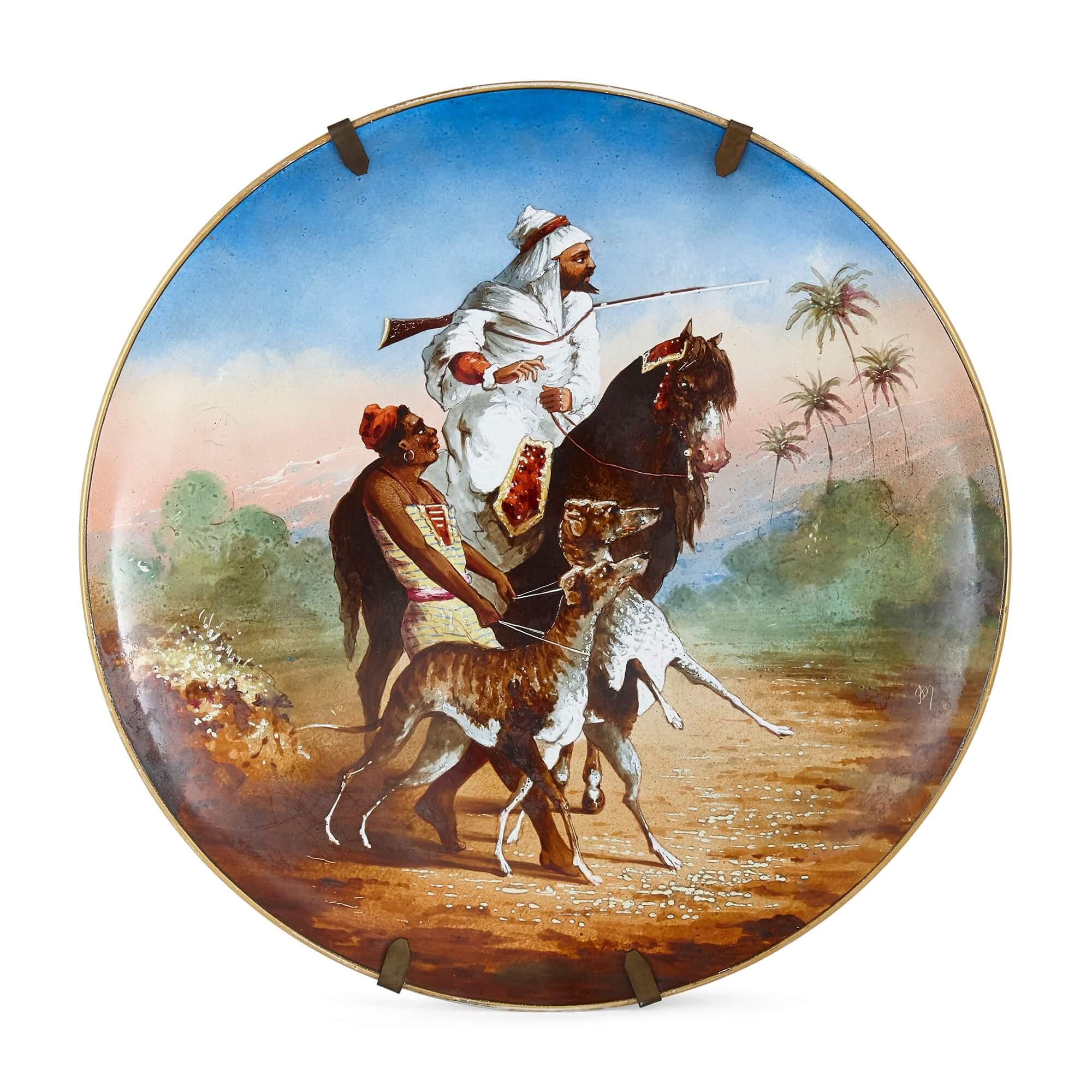 Antique pair of Orientalist painted porcelain plates
French, 19th Century
Height 5cm, diameter 35.5cm

The pair of plates are finely painted, one depicting two Arabic men on horseback in a landscape, and the other depicting a horseman with his dogs