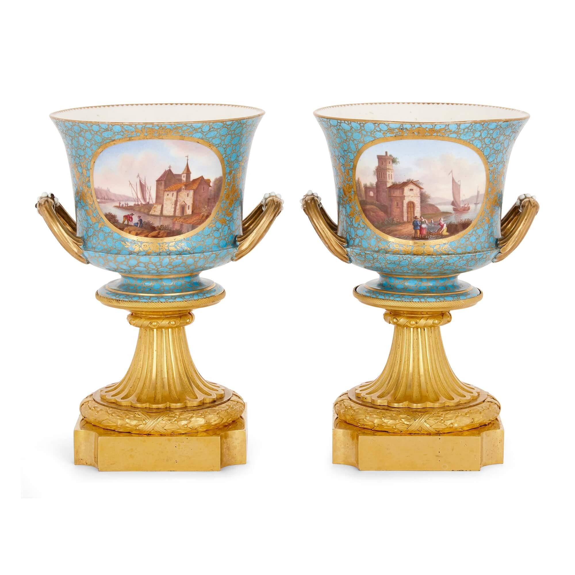 Antique pair of gilt bronze and Sèvres style porcelain cachepot vases
French, 19th Century
Height 24.5cm, width 17cm, depth 15cm

The vases in this elegant pair have been mounted with gilt bronze and decorated in the style of the Sèvres
