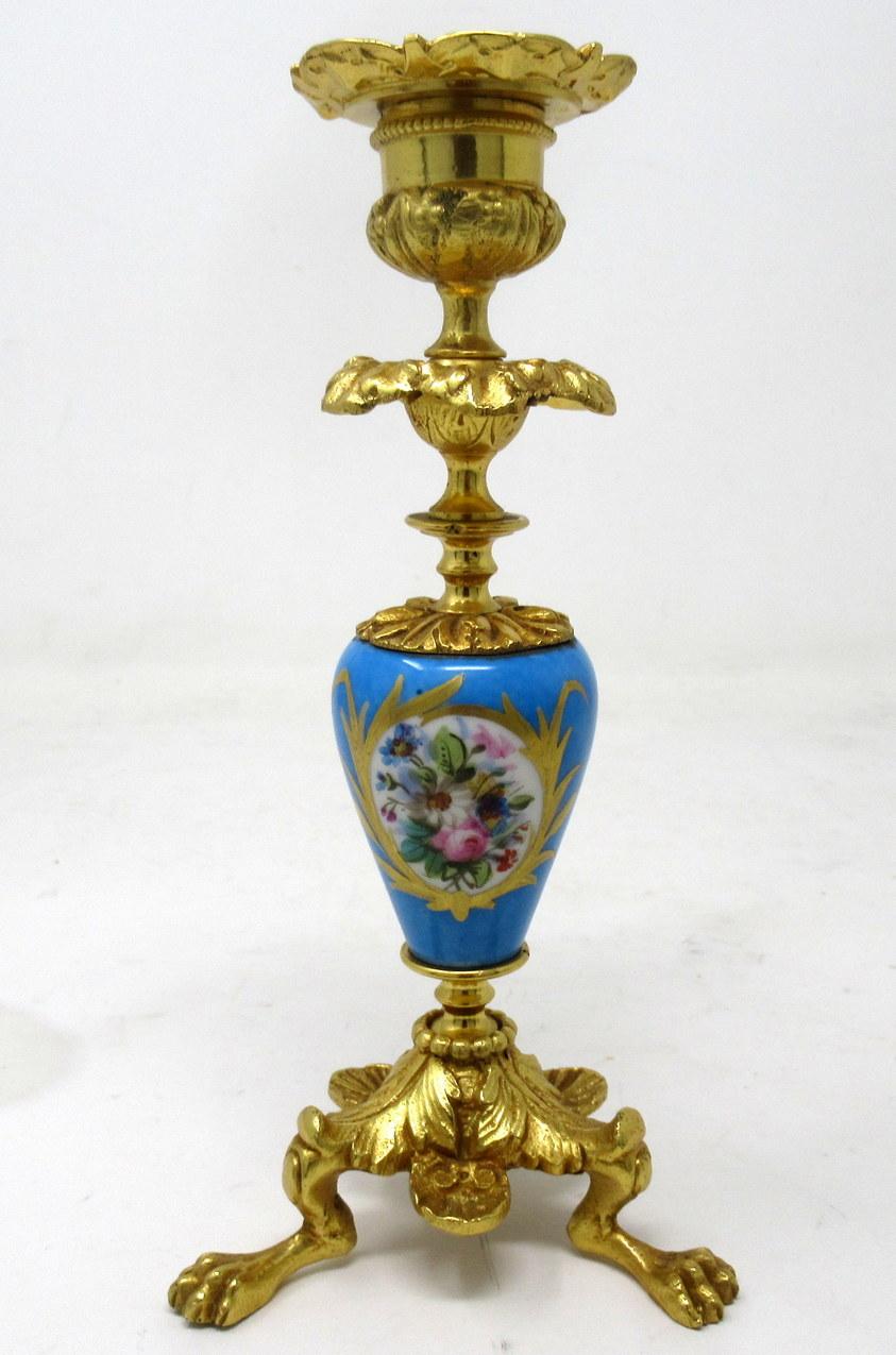 A fine pair of stylish and imposing French Ormolu & Sèvres Porcelain heavy gauge single light candlesticks of outstanding quality and of compact proportions. Last half of the nineteenth century.

Each with a central ovoid form porcelain support