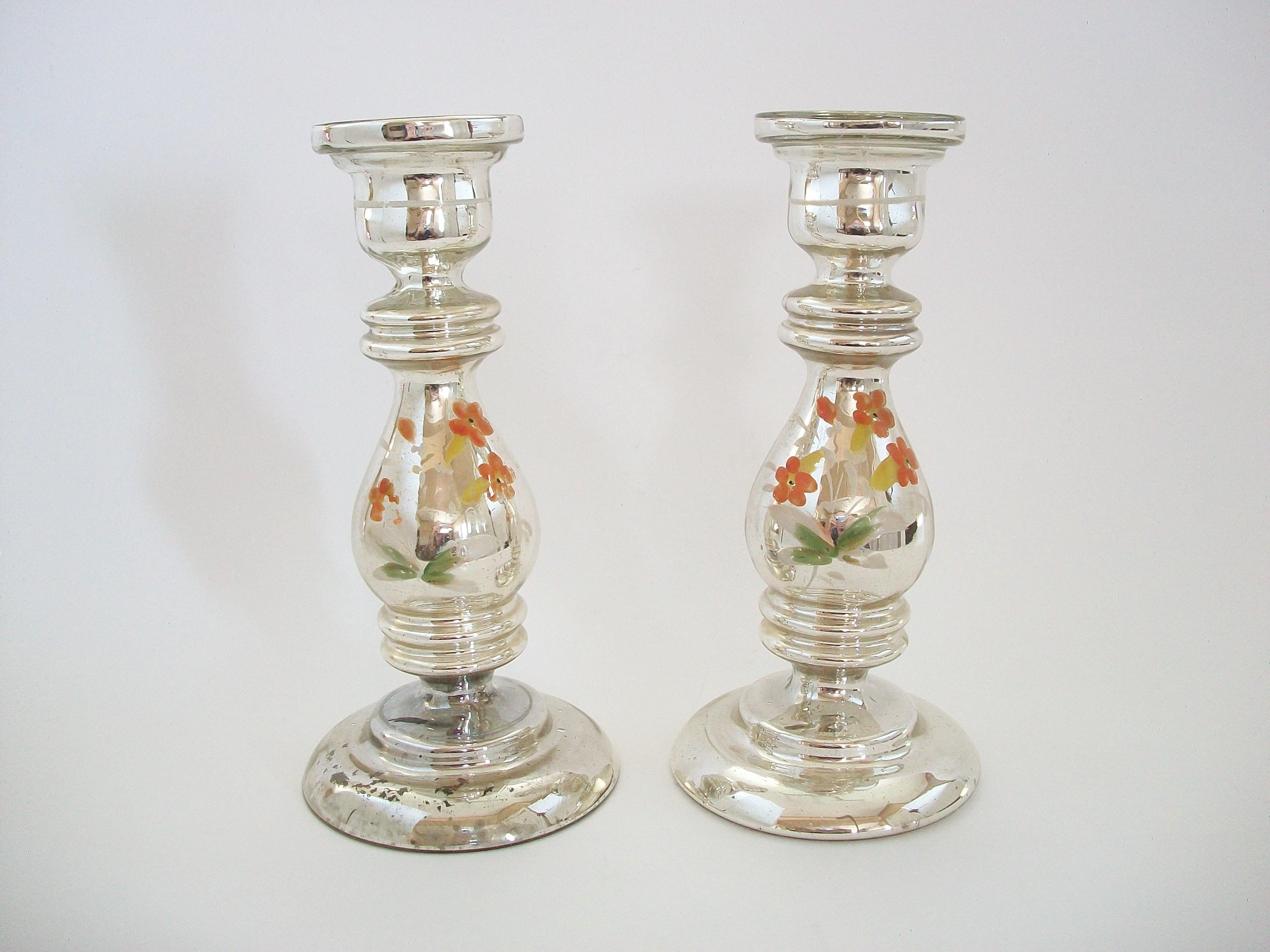 Large antique pair of painted Mercury glass candlesticks - featuring hand painted flowers to the front of each and bands to the sockets - one with original factory sticker - France - circa 1880.

Excellent antique condition - paint loss - minor