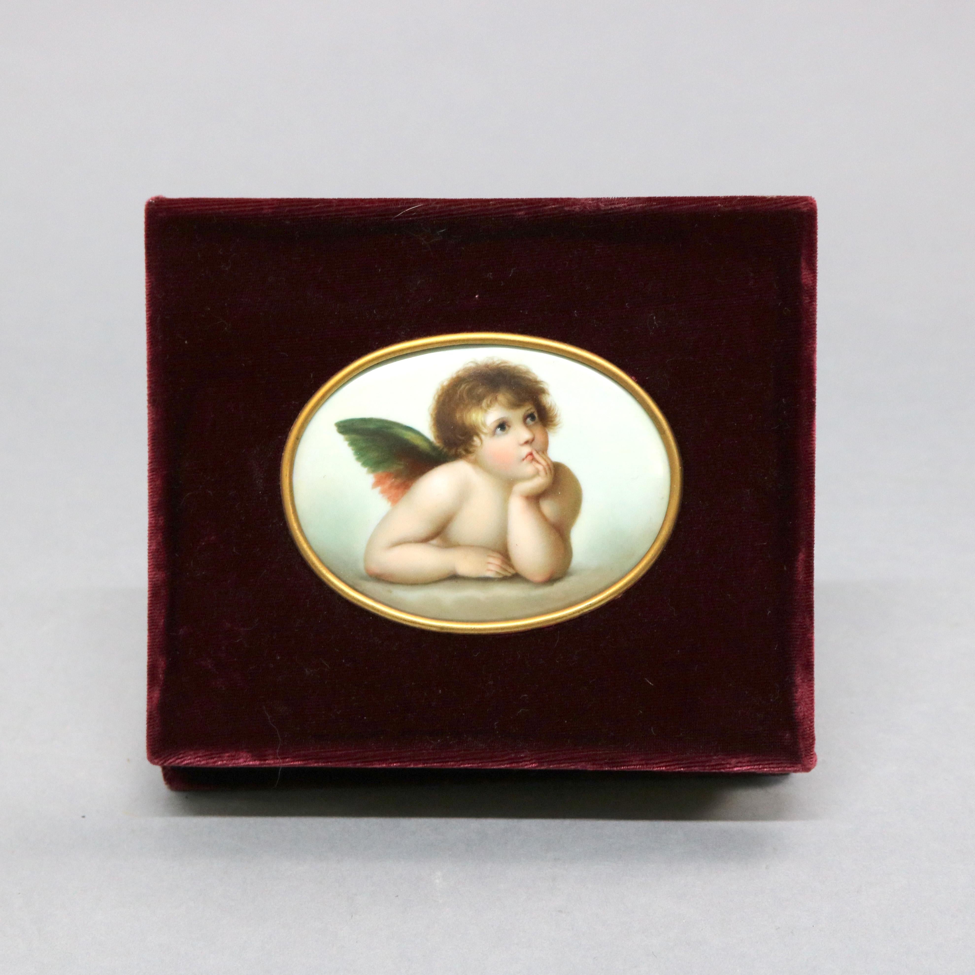 An antique pair of paintings on porcelain depict Classic winged cherubs, seated in velvet frame, 19th century

Measures: 12