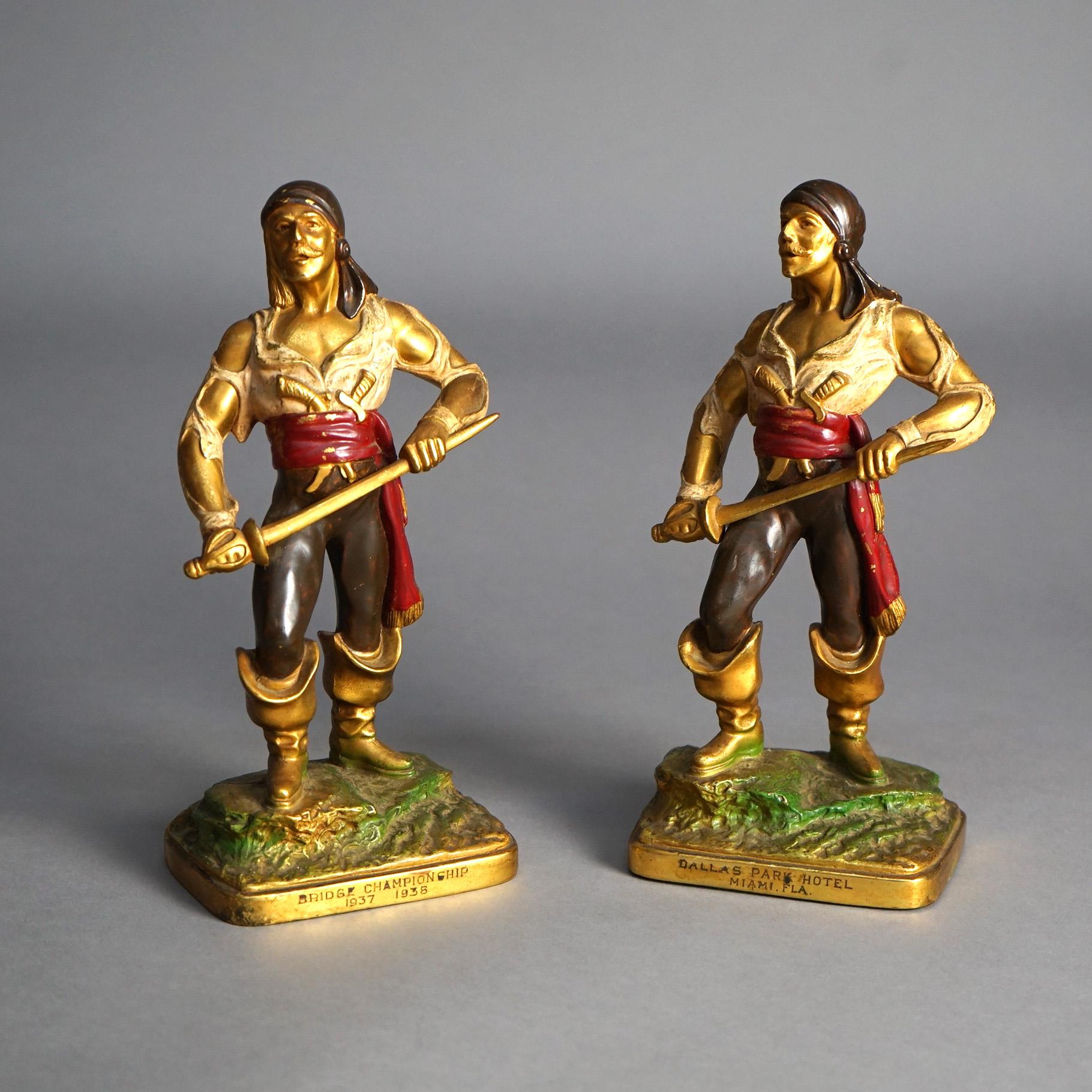 An antique pair of pirate figures offer bronzed and polychromed cast metal construction with 