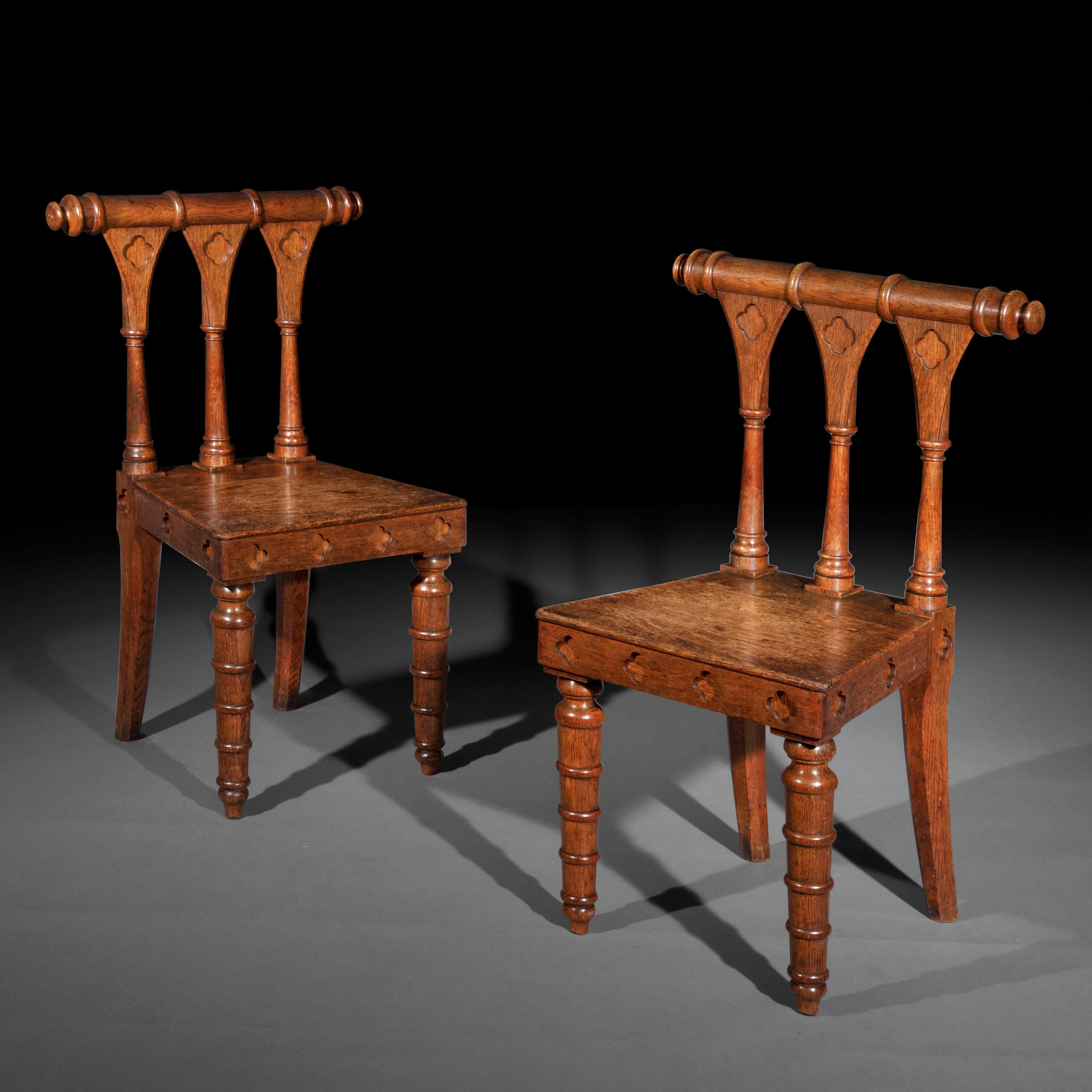 A pair of unusual oak hall chairs of the late Regency, in the manner of George Smith or Richard Bridgens.

England, circa 1825.

Why we like them

The architectural boldness and chunkiness of these hall chairs is highly unusual. Also of great colour