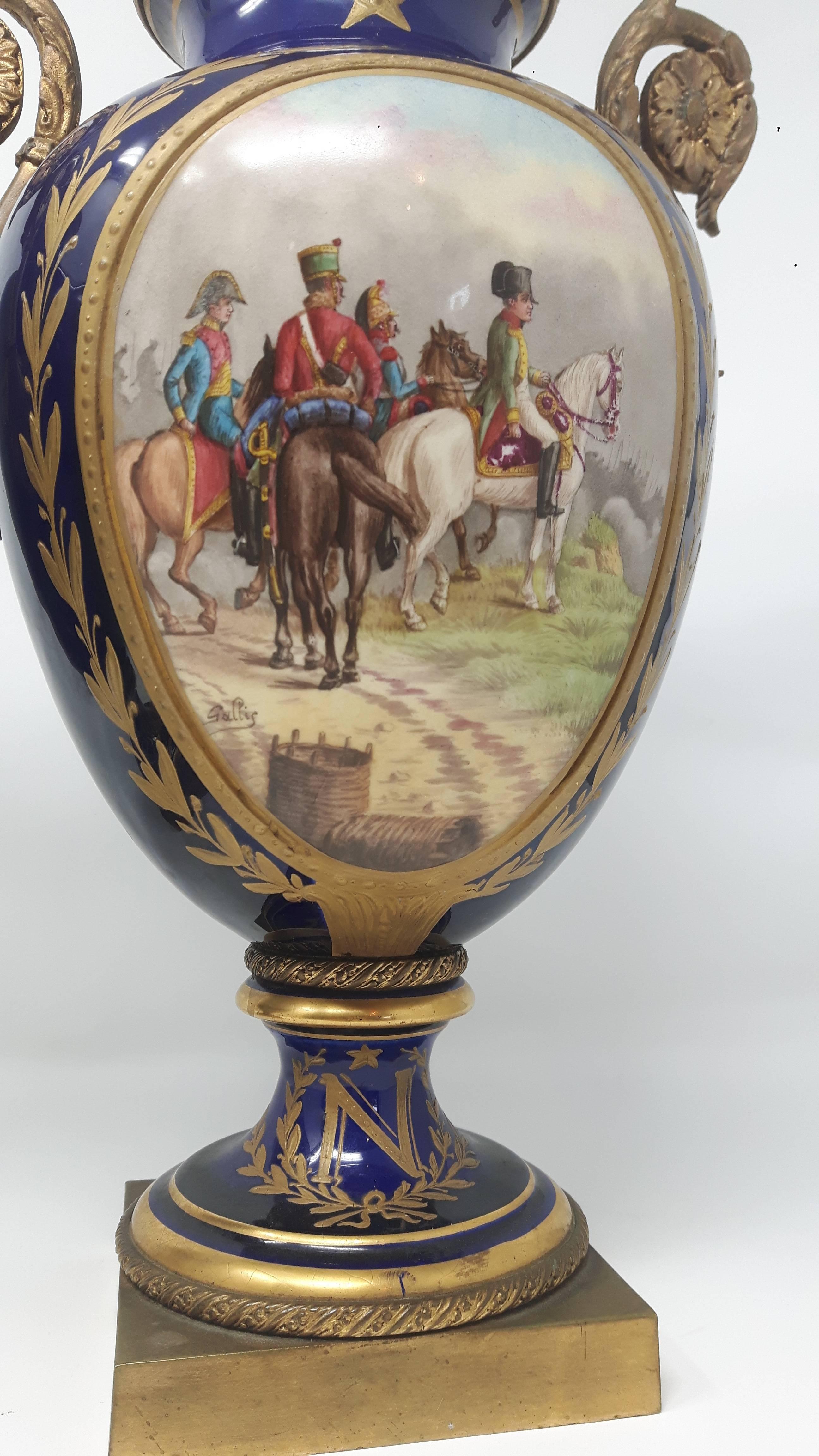 A pair of fine quality ormolu-mounted serves vases, delicately painted with scenes of Napoleon and his soldiers on horseback on one panel and scenery on the back panel.
 