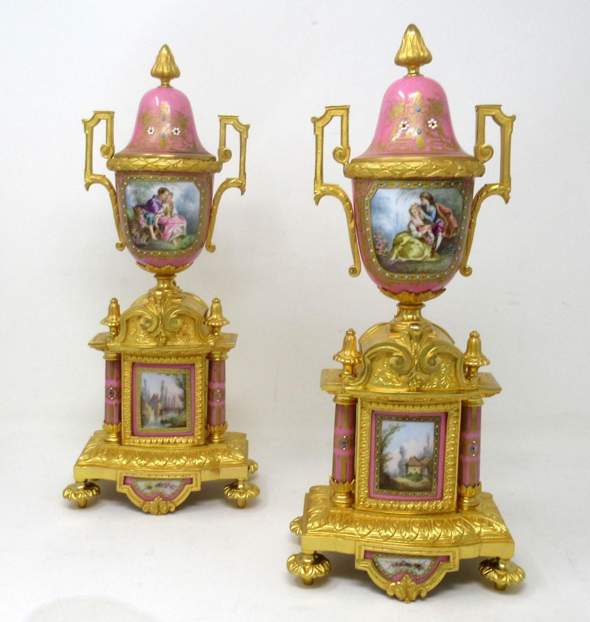 Stunning Pair French Sevres Soft Paste Hand Decorated Pompadour Pink Porcelain and Ormolu Twin Scroll Handle Table or Mantle Urns of traditional form and of outstanding quality, made during the last half of the Nineteenth Century. 

Each urn of