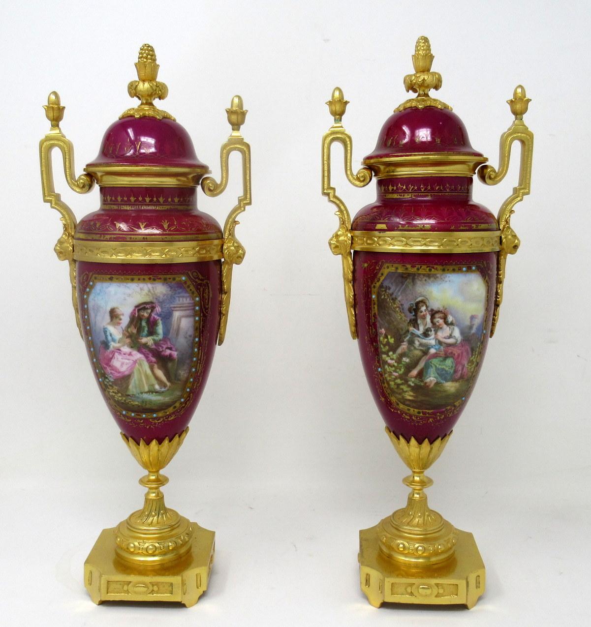 Stunning pair French sevres soft paste hand decorated rich burgundy porcelain and ormolu twin scroll handle table or mantle urns of traditional form and of outstanding quality, made during the last half of the Nineteenth century. 

Each urn of