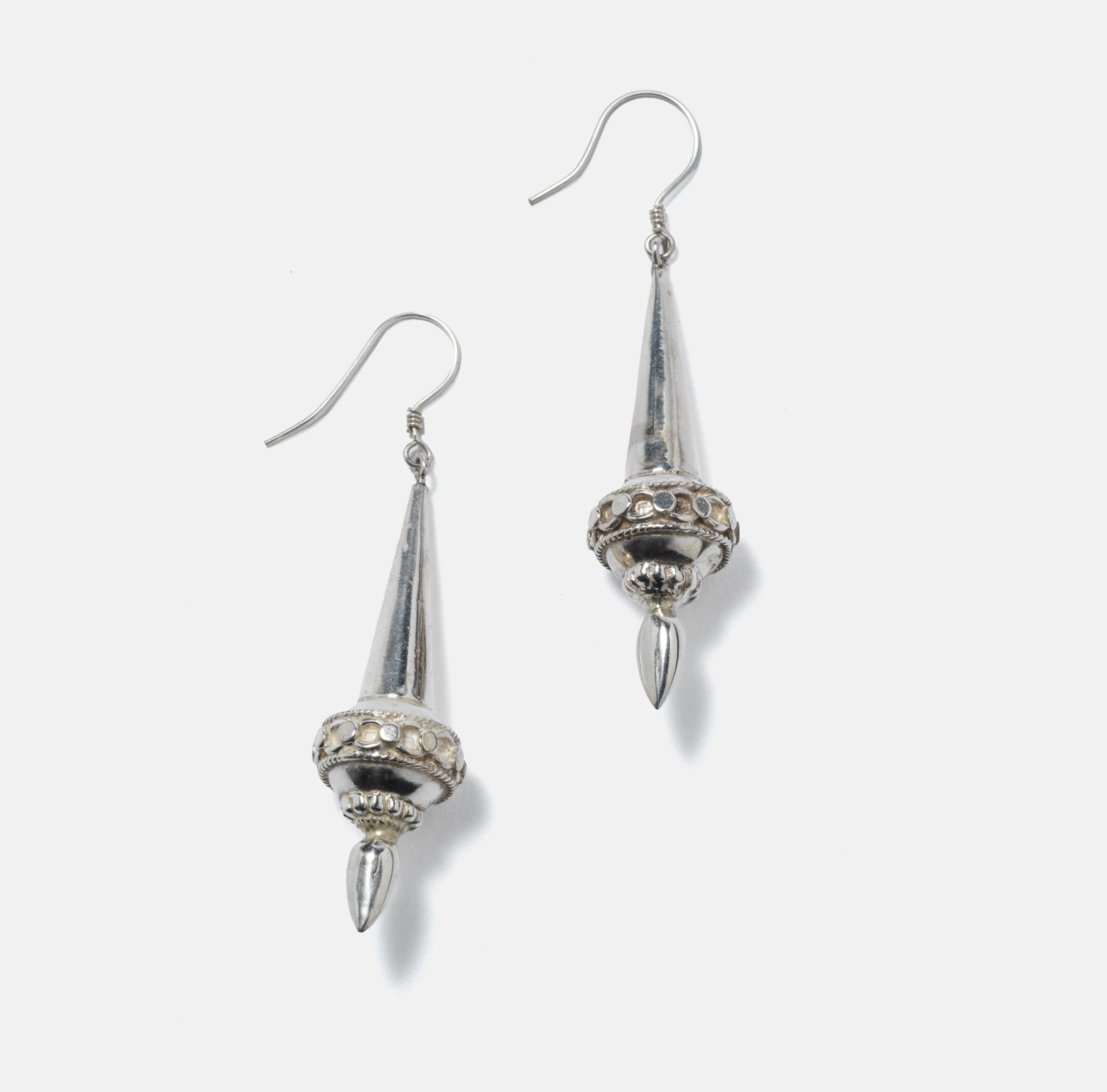 A pair of silver earrings designed almost like Christmas tree decorations. They are hollow ad therefore hang light and easy on your ears.
These are ear rings made in Northern Europe but influenced by Arabic designs. Something like Alladin.
These can