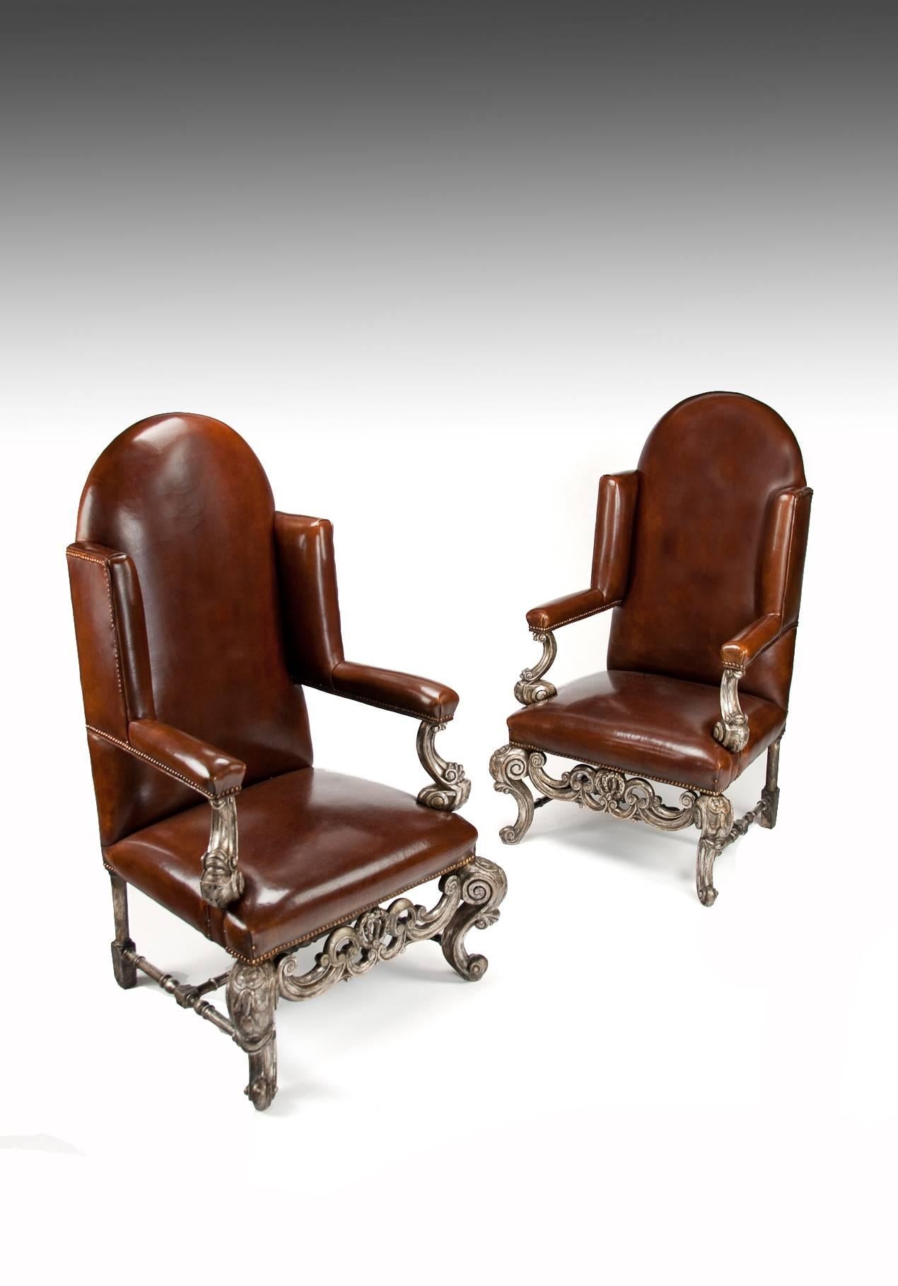 A very unusual and good quality pair of silver gilt leather upholstered wing armchairs dating to circa 1880-1900.
This decorative and rare pair of leather upholstered wing armchairs have been constructed in the William and Mary style. 

With