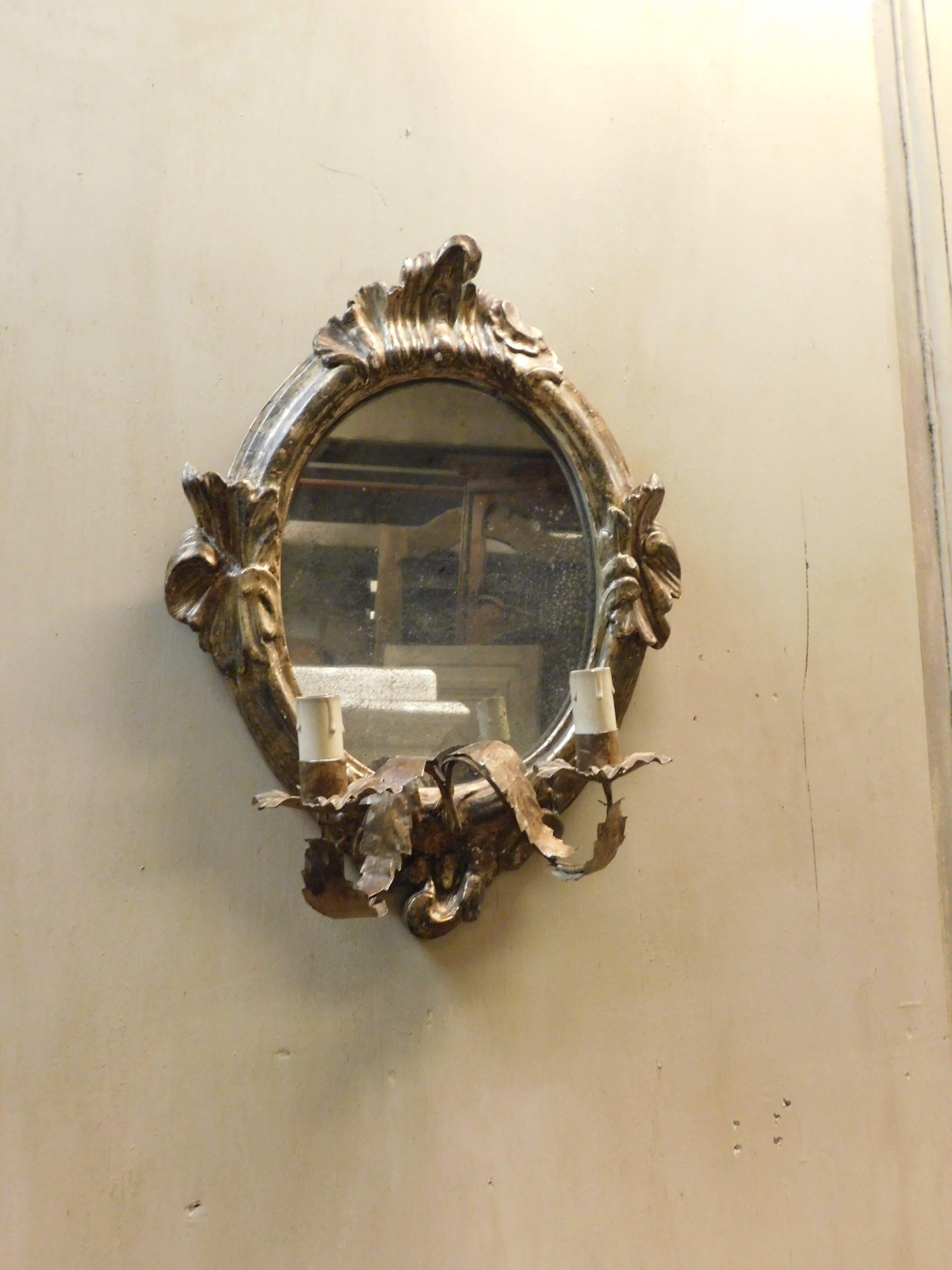 Antique pair of small mirrors with original silver plating, fans with arms for double lights in wrought iron, sold only in pairs, built in the 18th century, for home interiors in Italy.
Historical and of great value, really suitable for any place