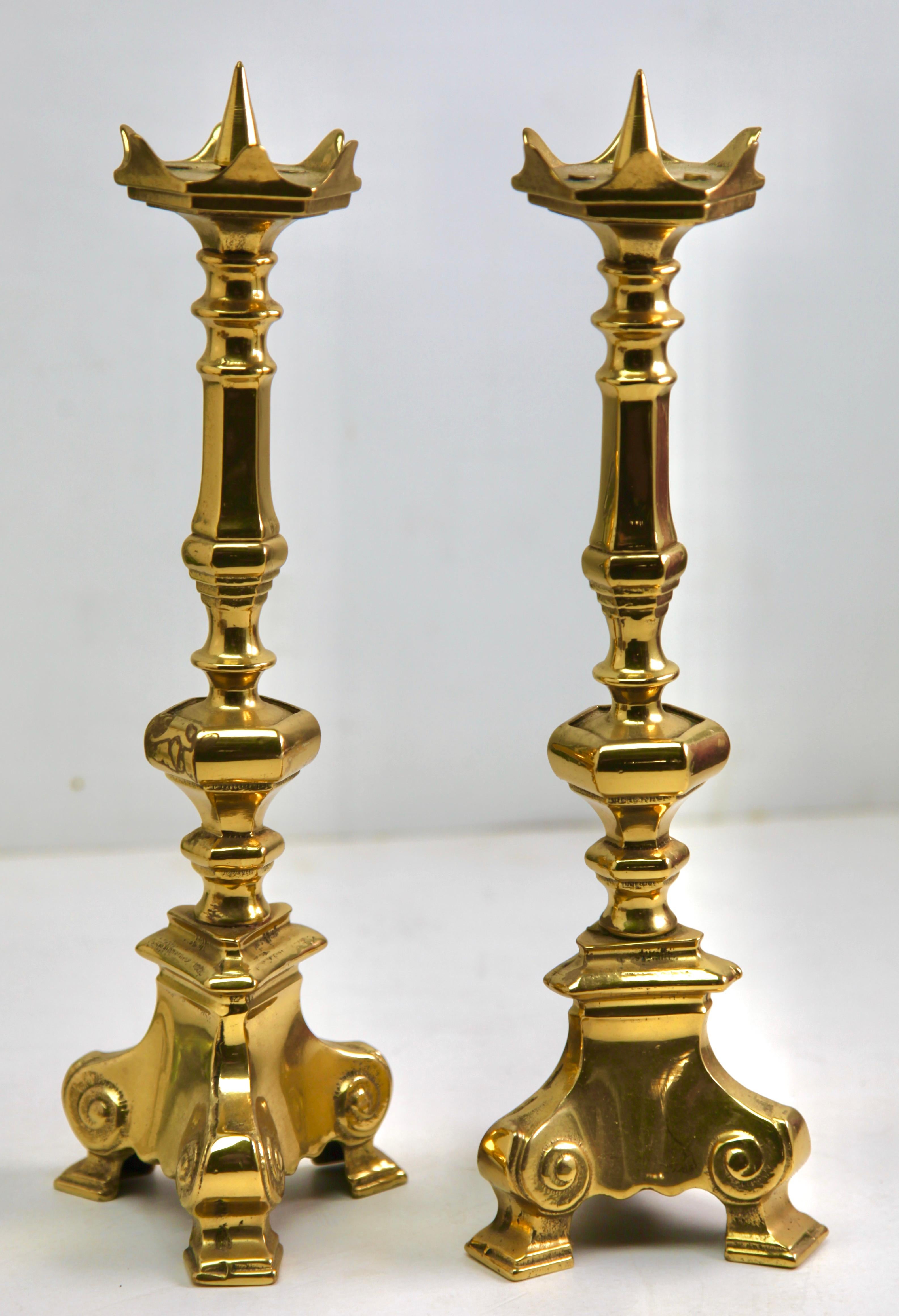 Antique pair of solid brass candlesticks.

The solid brass is sharply cast and well defined, and are an 
identical pair. They each stand solidly on three feet.




