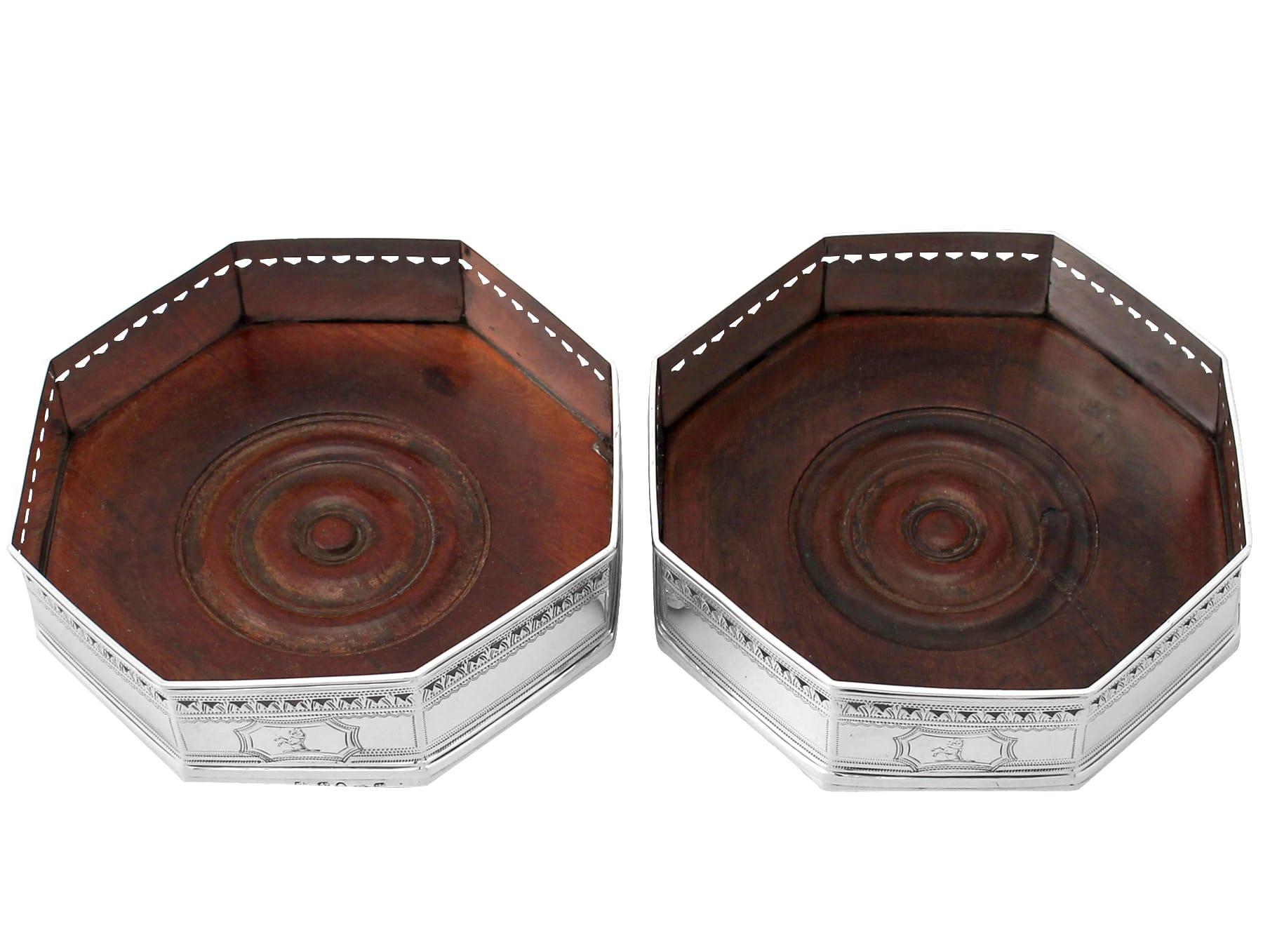 A fine and impressive pair of antique Georgian English sterling silver coasters; an addition to our wine and drinks related silverware collection

These fine antique George III sterling silver coasters have an octagonal shaped form onto a stepped