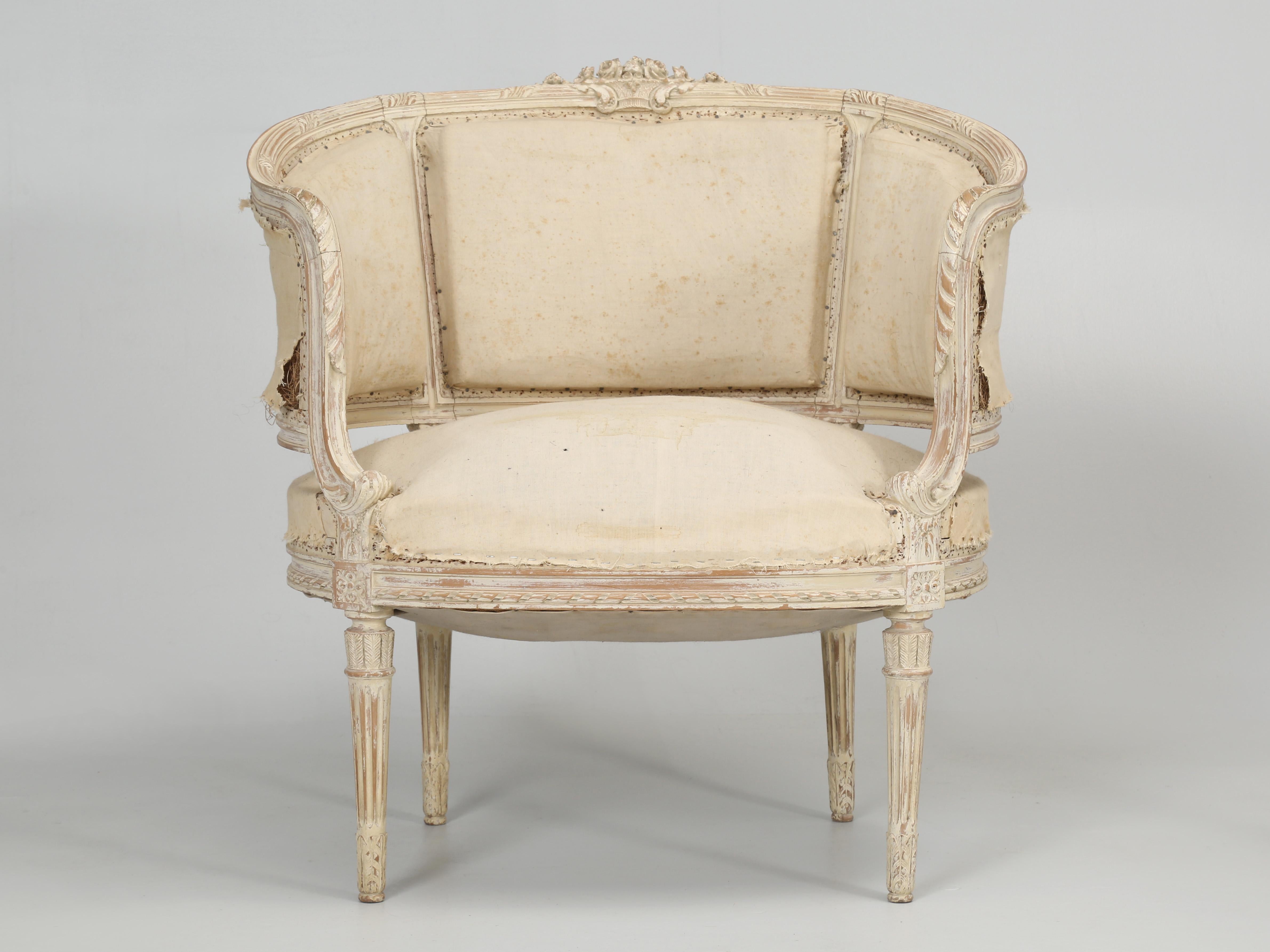 Antique pair of Louis XVI style Swedish bergère chairs in old paint, a bergère chairs is defined as; an upholstered armchair of an 18th century style having an exposed wood frame. This particular pair of antique painted Swedish arm chairs are being