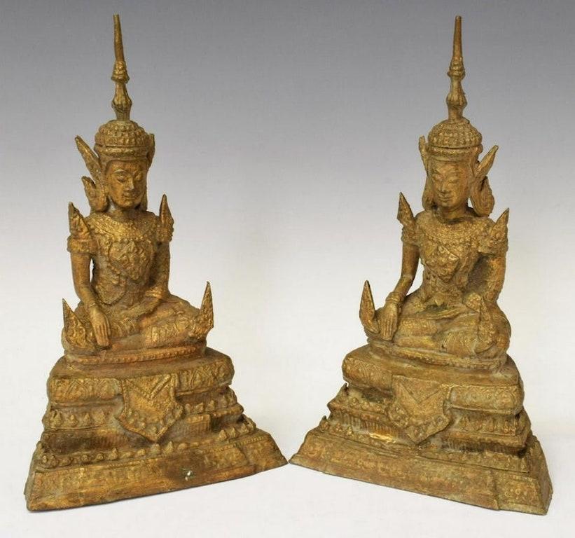 A pair of early 20th century (possibly late 19th c.) Thai Rattanakosin Kingdom period patinated cast bronze gilded Buddha sculptures. Featuring richly detailed and decorated figures of Buddha, seated on stepped base. The Southeastern Asian antiques