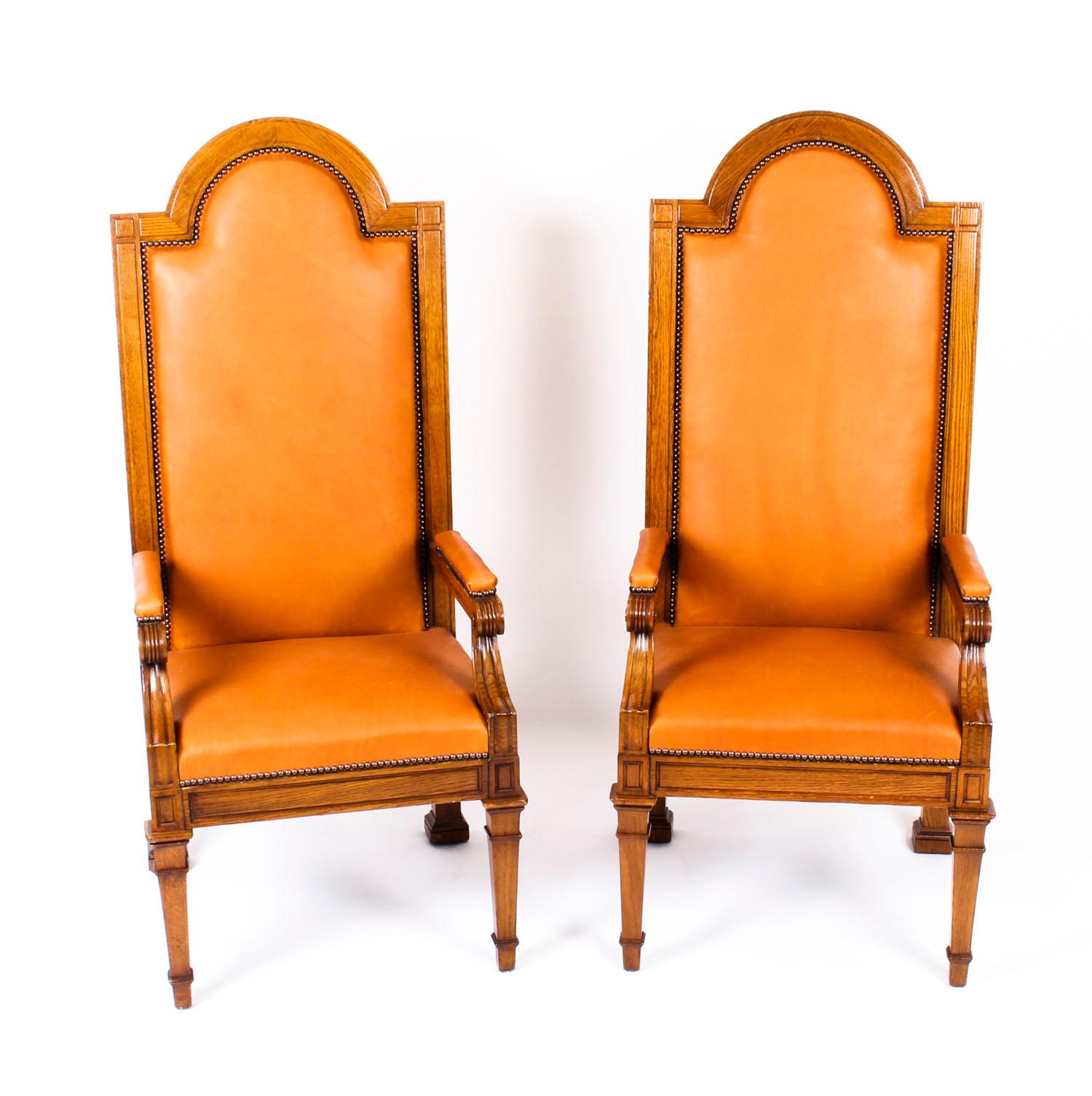 This is a truly impressive antique pair of Victorian solid oak high backed Judges Throne chairs, circa 1870 in date.

The solid oak frames have been skillfully carved in the medieval Gothic influence in the form of thrones with distinctive high