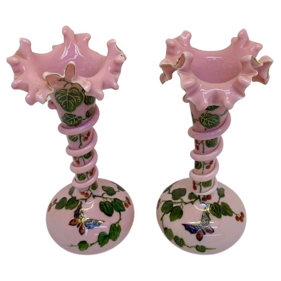An exceptional pair of victorian snake vases in pink opaline glass

hand-painted all around with colorful enamel decoration featuring leaves and butterflies

each vase with undulated rim and a snake around the neck

Height 28 cm