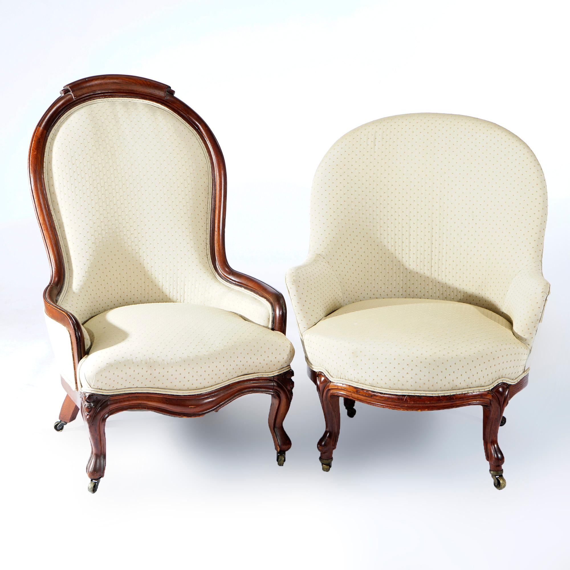 An antique pair of Victorian parlor chairs offer walnut construction with upholstered seats and back raised on cabriole legs with carved knees, c1900

Measures- 40.25''H x 25''W x 27.75''D
