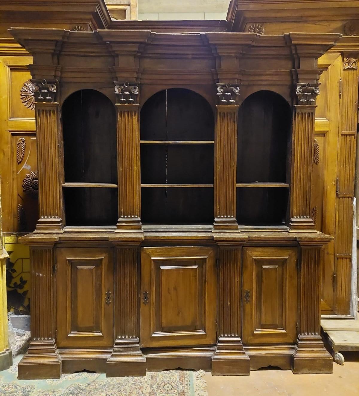 Ancient walnut bookcases, with the lower part with doors and the upper part with arched openings, derived from ancient confessionals which in the 19th century were transformed into bookcases. Coming from northern Italy, in beautiful antique and