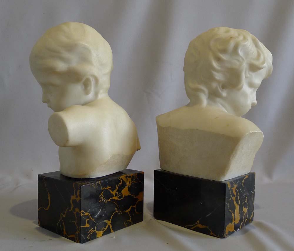 Antique pair of white marble busts of children on variegated marble bases. One child looking to Sinister and one to Dexter. Very nice quality sculpting of the faces. Probably Italian.