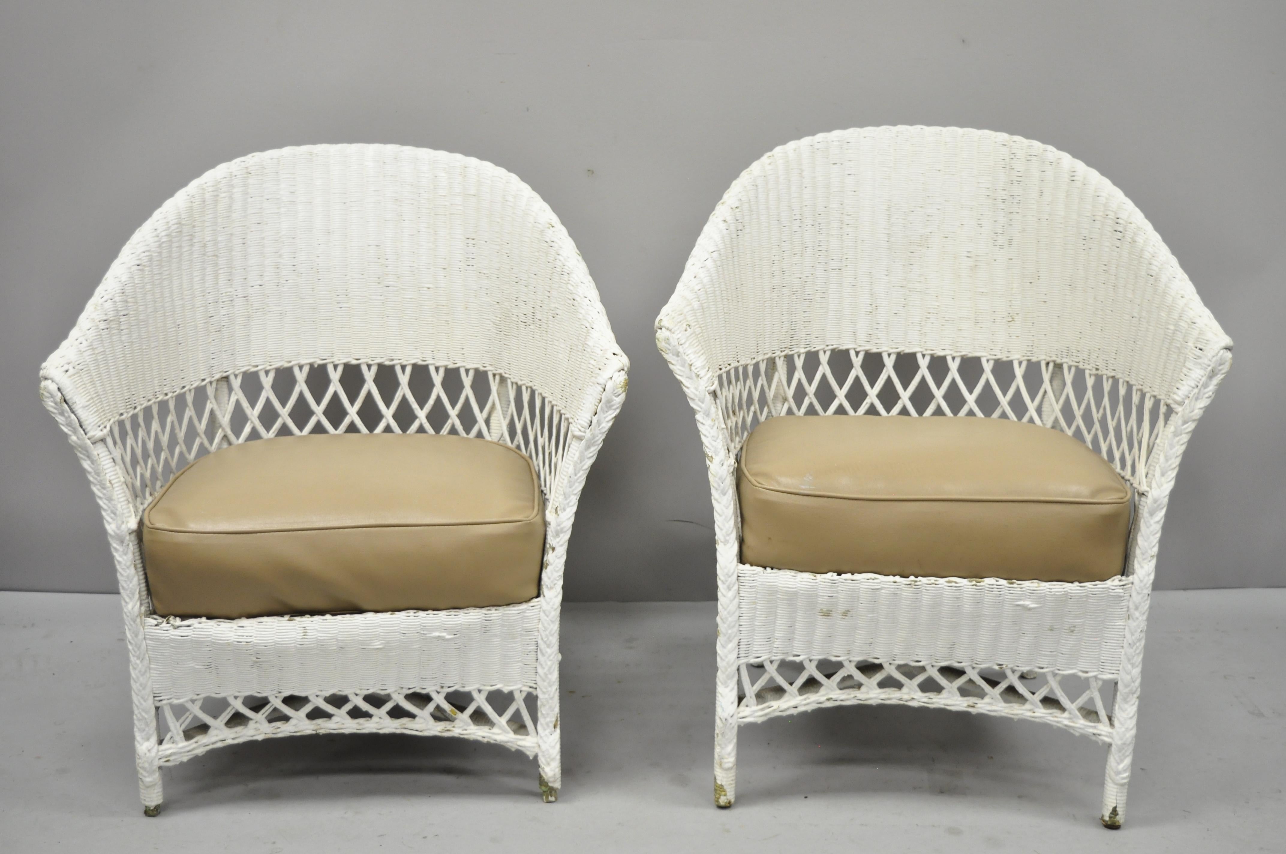 Antique pair of white wicker rattan his and hers sunroom Victorian armchairs. Listing features His and hers armchairs (slight variance in size), wicker frames, vinyl seats, very nice vintage item, quality American craftsmanship, circa early 20th