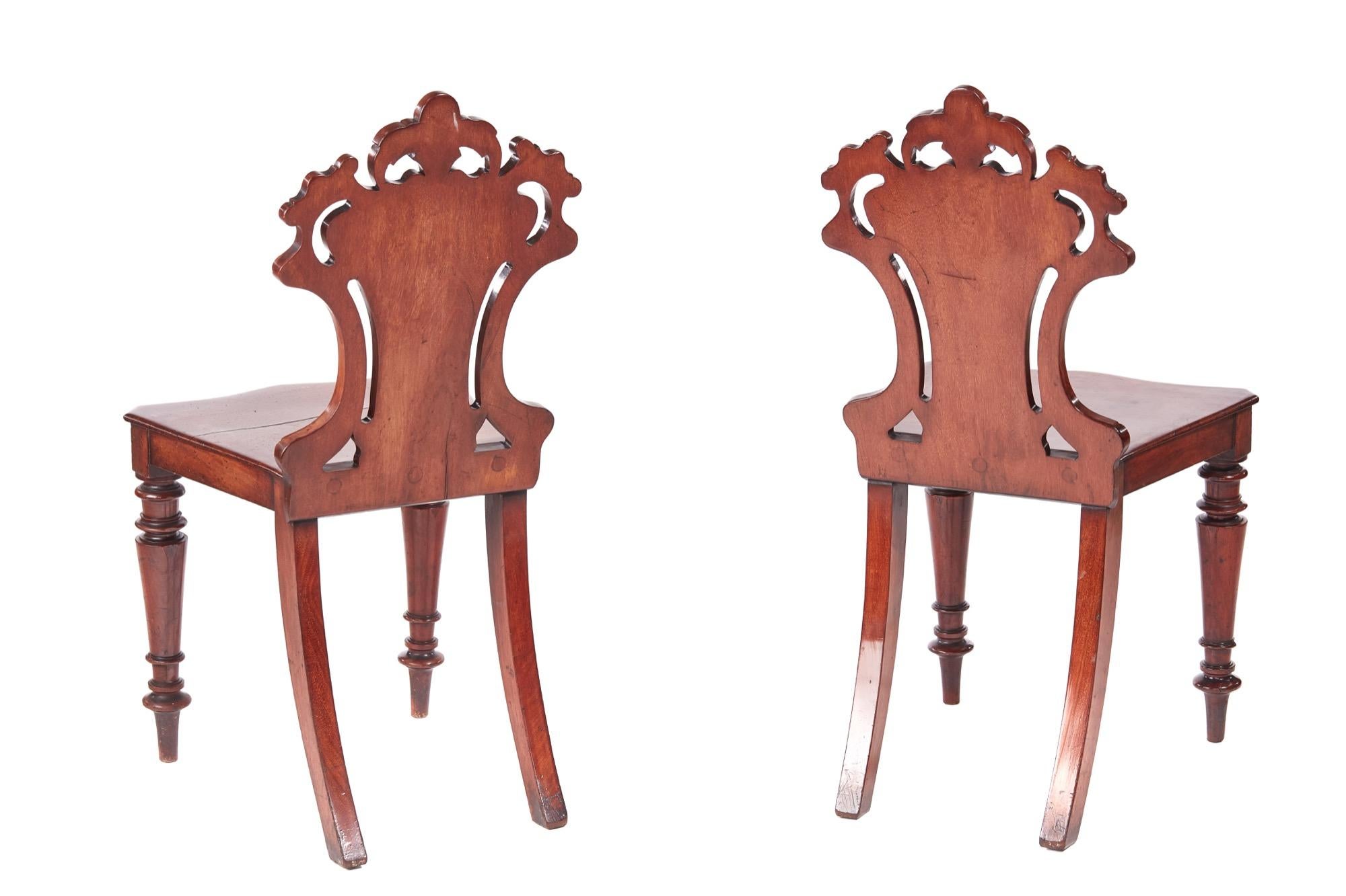 Quality pair of William IV mahogany hall chairs with expertly carved solid mahogany shaped backs, mahogany seats and elegant shaped turned legs to the front and out swept back legs.

These chairs are beautifully designed in a wonderful color and