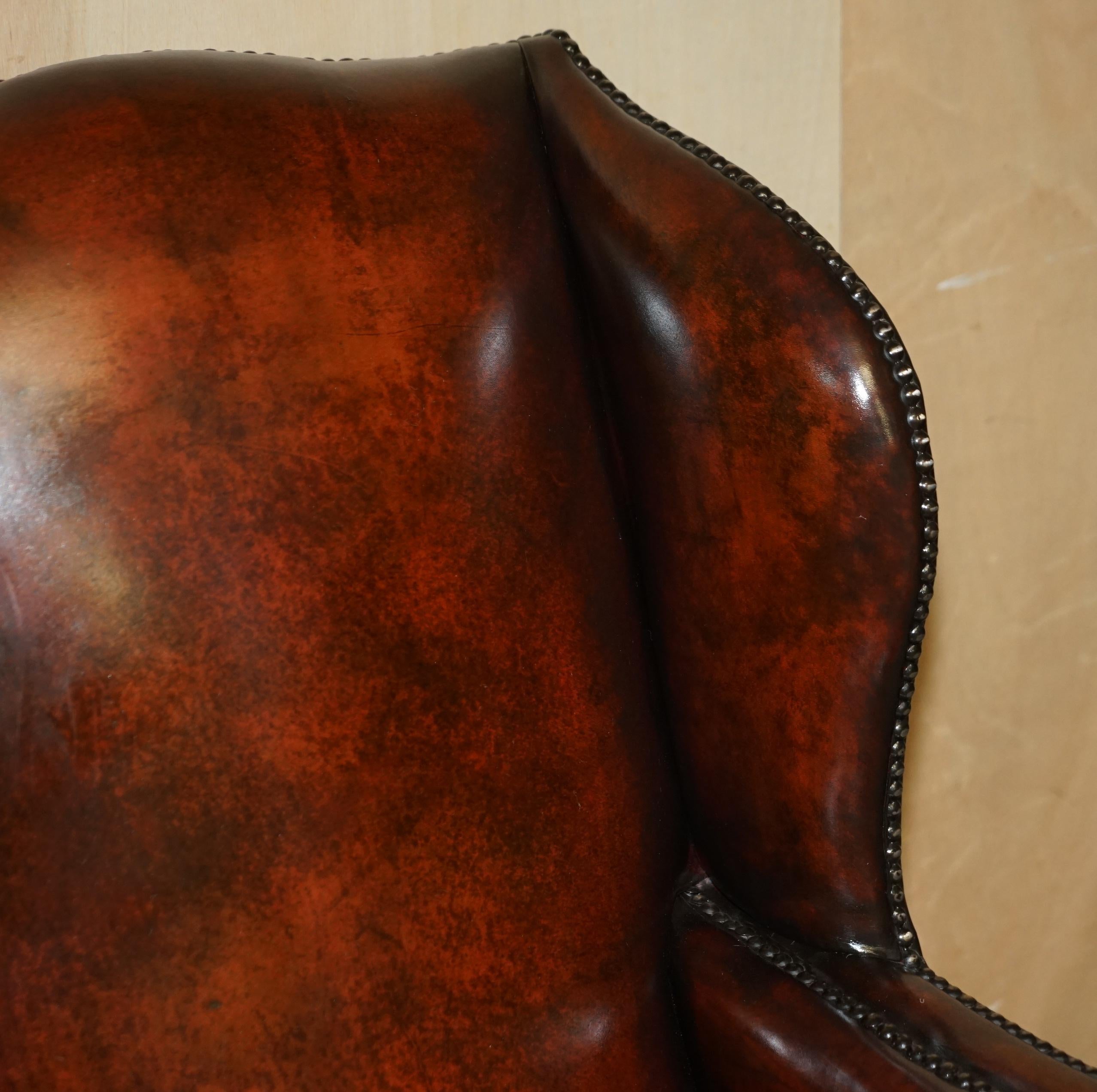 Mid-19th Century Antique Pair of William Morris Carved Legged Wingback Bordeaux Leather Armchairs