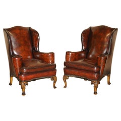 Antique Pair of William Morris Carved Legged Wingback Bordeaux Leather Armchairs