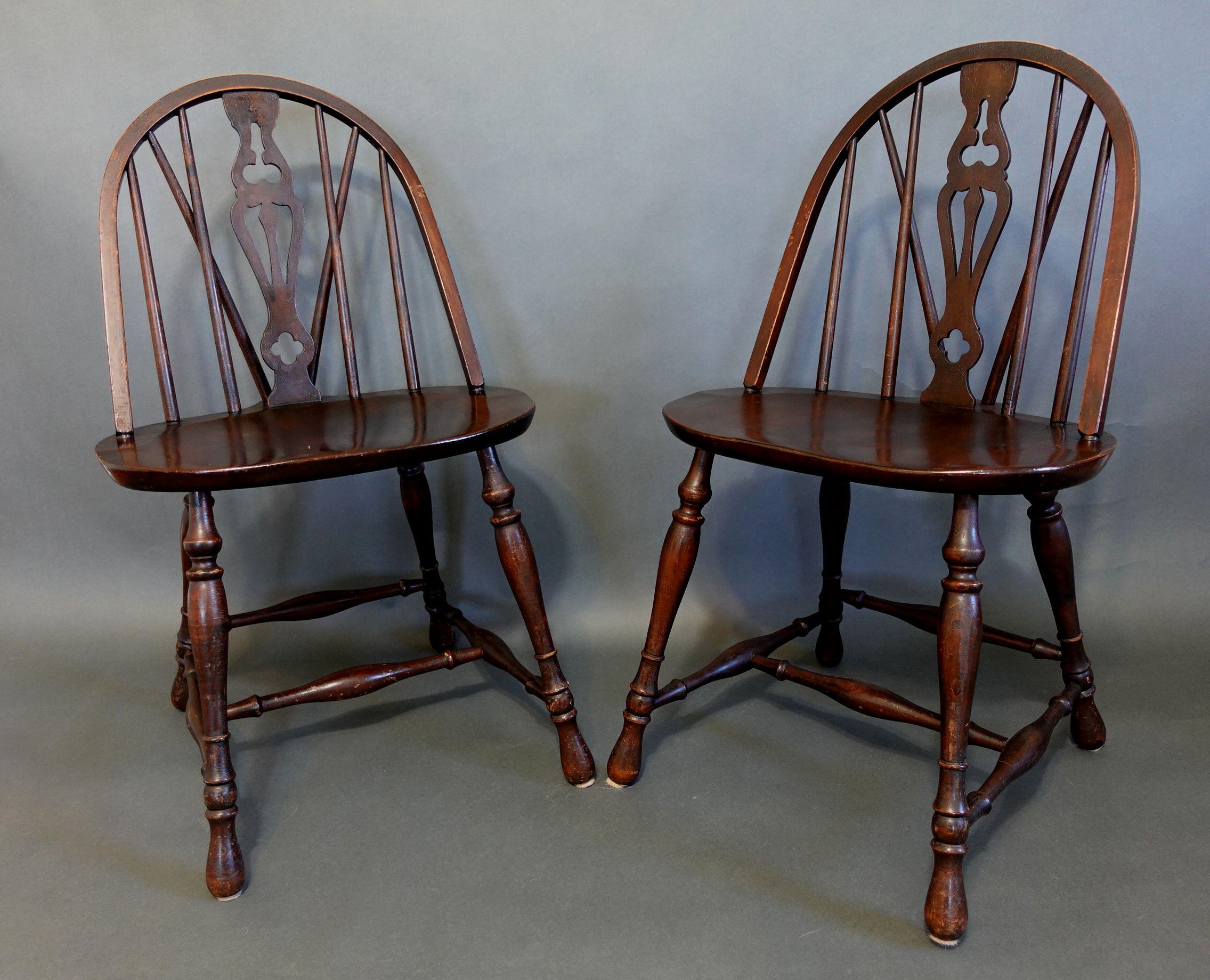 Adorable antique pair of Windsor bow-brace back dining chairs with a decorative splat and finely turned legs and stretcher, in ash with coordinated host and Hostess chairs with rushed seating details.
