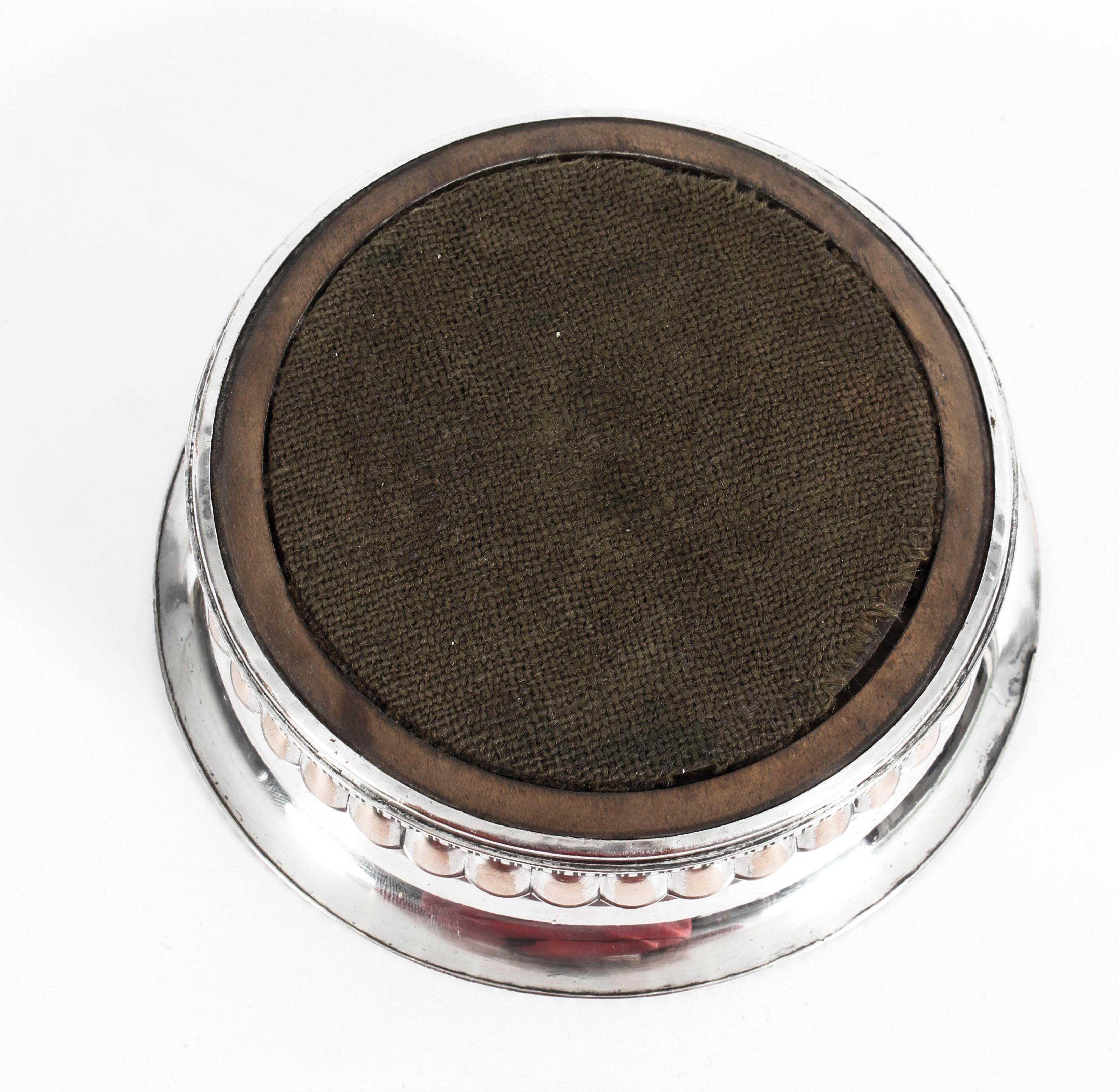 This is a very attractive pair of English antique old Sheffield silver on copper wine bottle coasters, circa 1820 in date.

These beautiful wine coasters have inset hand-turned mahogany bases and feature exquisite gadrooned decoration to the