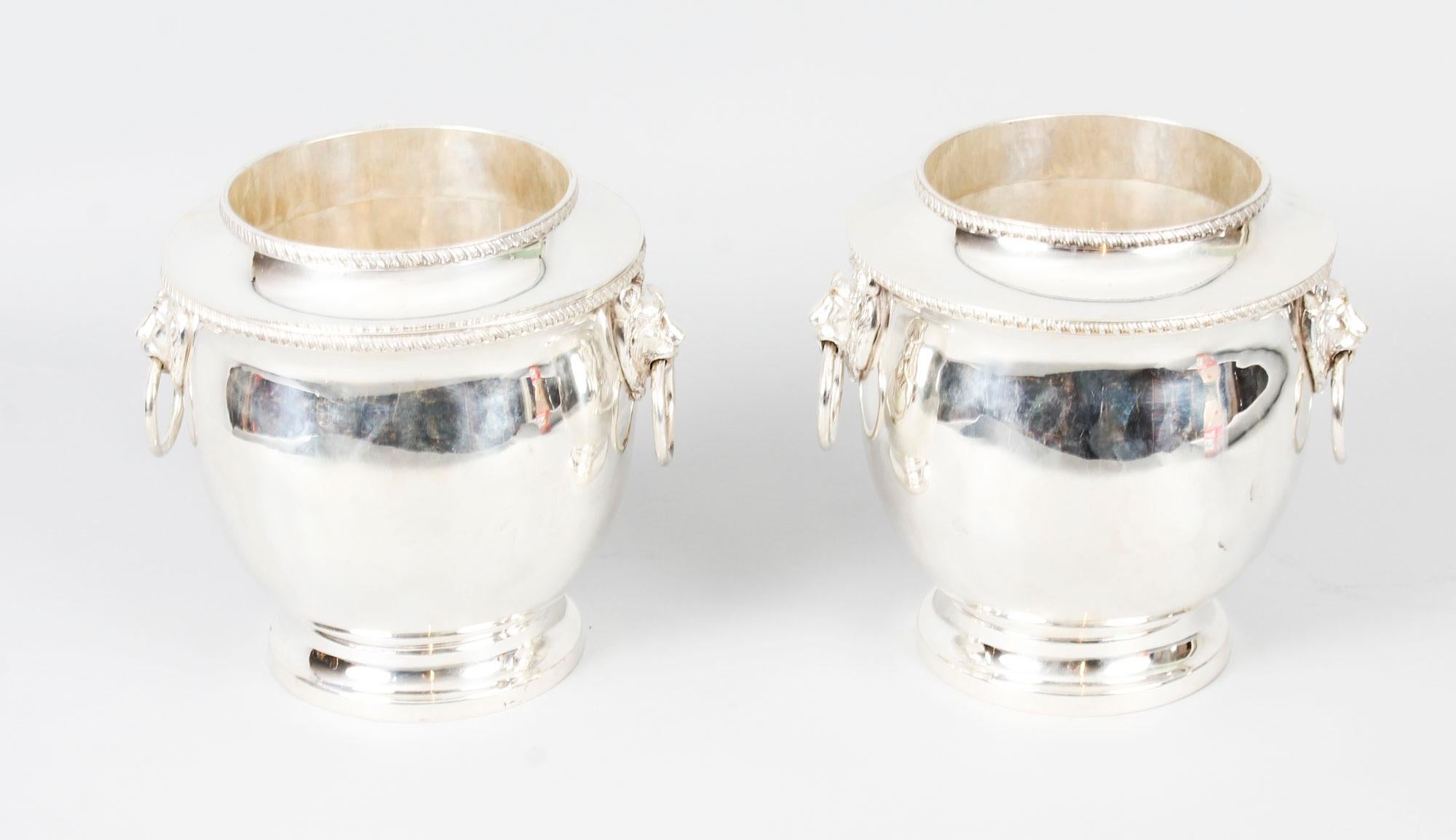 This is a wonderful and rare pair of antique Regency period, old Sheffield plate, silver on copper wine coolers, circa 1820 in date.

Each is of globular form with a circular pedestal foot, an exceptional pair of decorative lion head hoop handles