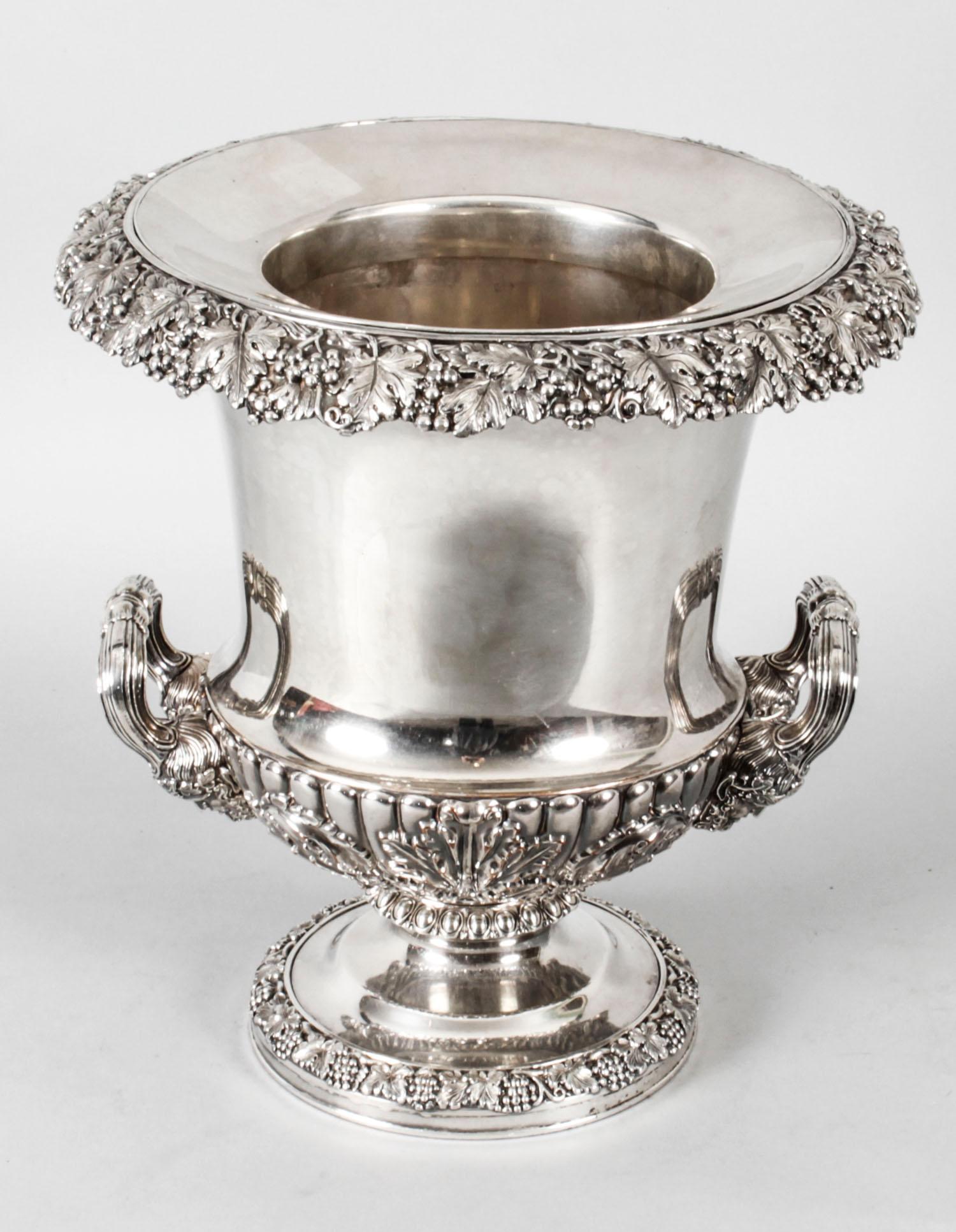 This is a fine and rare pair of antique English Old Sheffield Plate, silver on copper, Regency wine coolers by Creswick of Sheffield, circa 1820 in date.

Each is fitted with an exceptional pair of decorative handles embellished with chased leaf