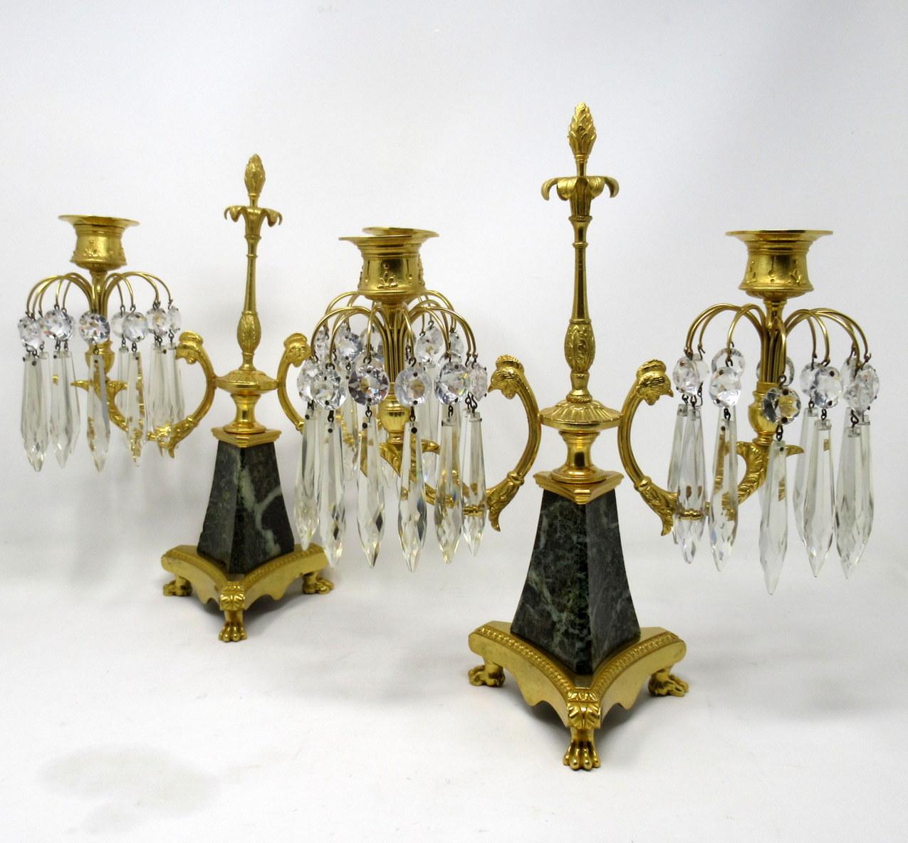 Stunning pair of French Louis XV style statutory marble and Ormolu twin light candelabra, after a model by Pierre Gouthiere (1732-1813), mid-19th century.

Each with a centered spire topped with a leaf canopy and an Acorn finial, issuing two