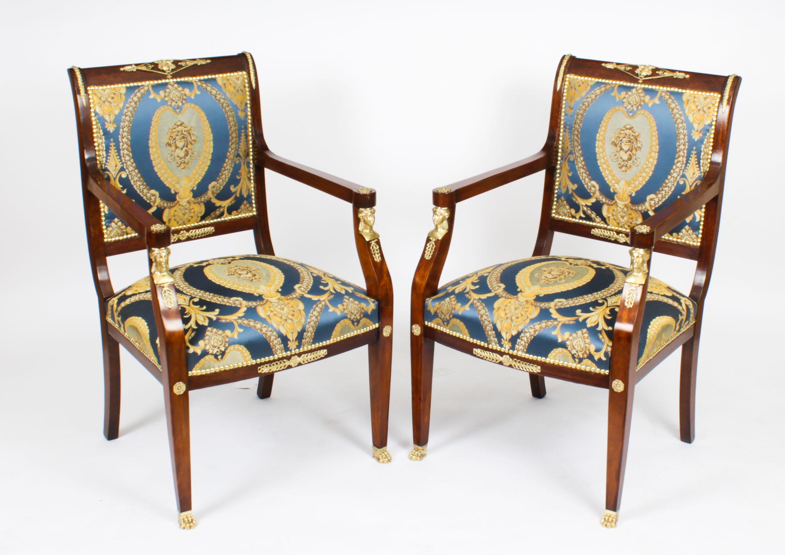 This is a fantastic and highly decorative antique pair of French ormolu mounted Empire fauteuil armchairs, circa 1870 in date.
 
They feature scrolled square padded backs mounted with laurel trails and Apollo masks above stuff-over seats flanked