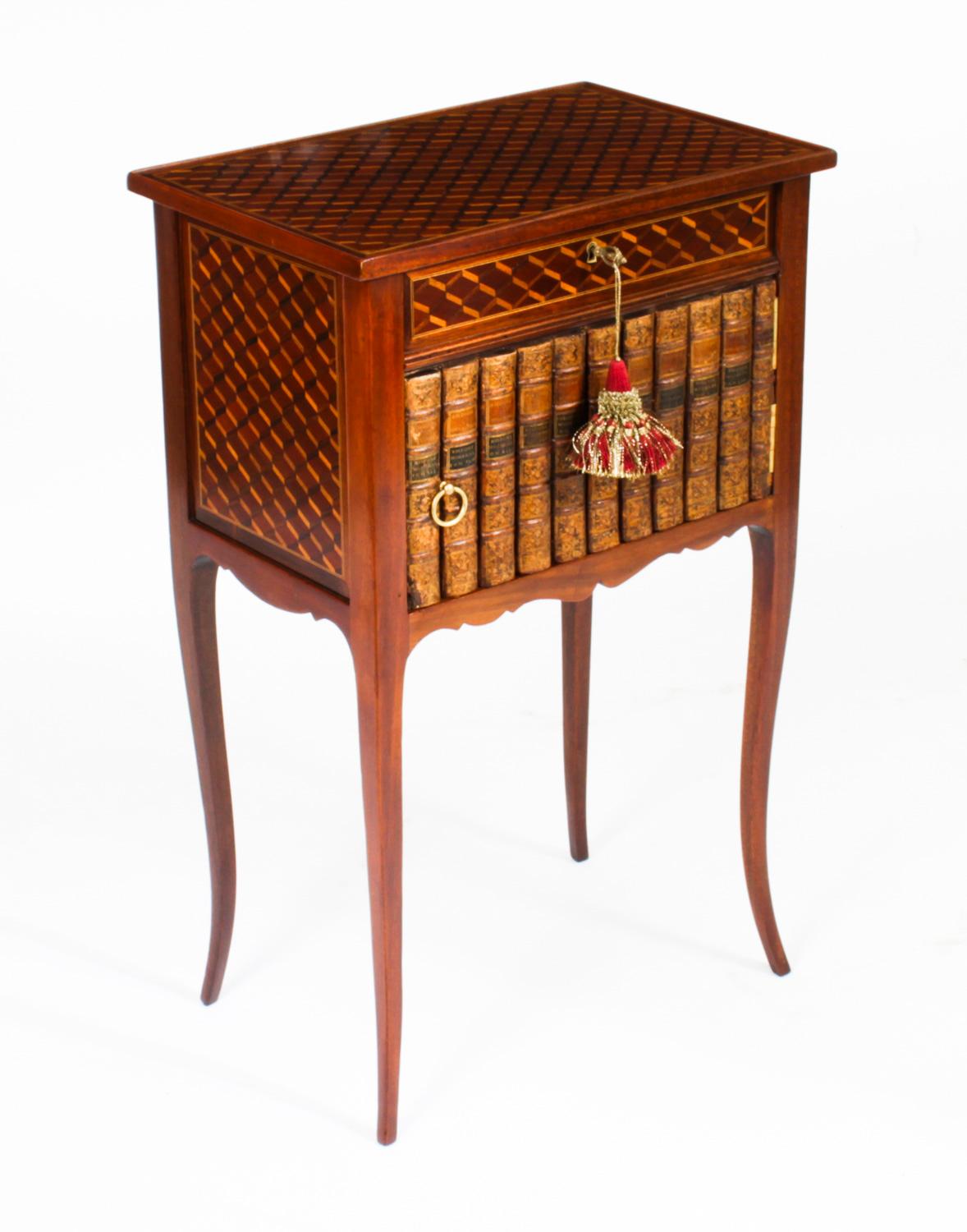 This is a beautiful pair of antique French Louis Revival parquetry occasional bedside tables, late 19th Century in date.
 
The hinged lift-up rectangular table tops are beautifully inlaid with diamond-shaped parquetry above faux book spine doors and