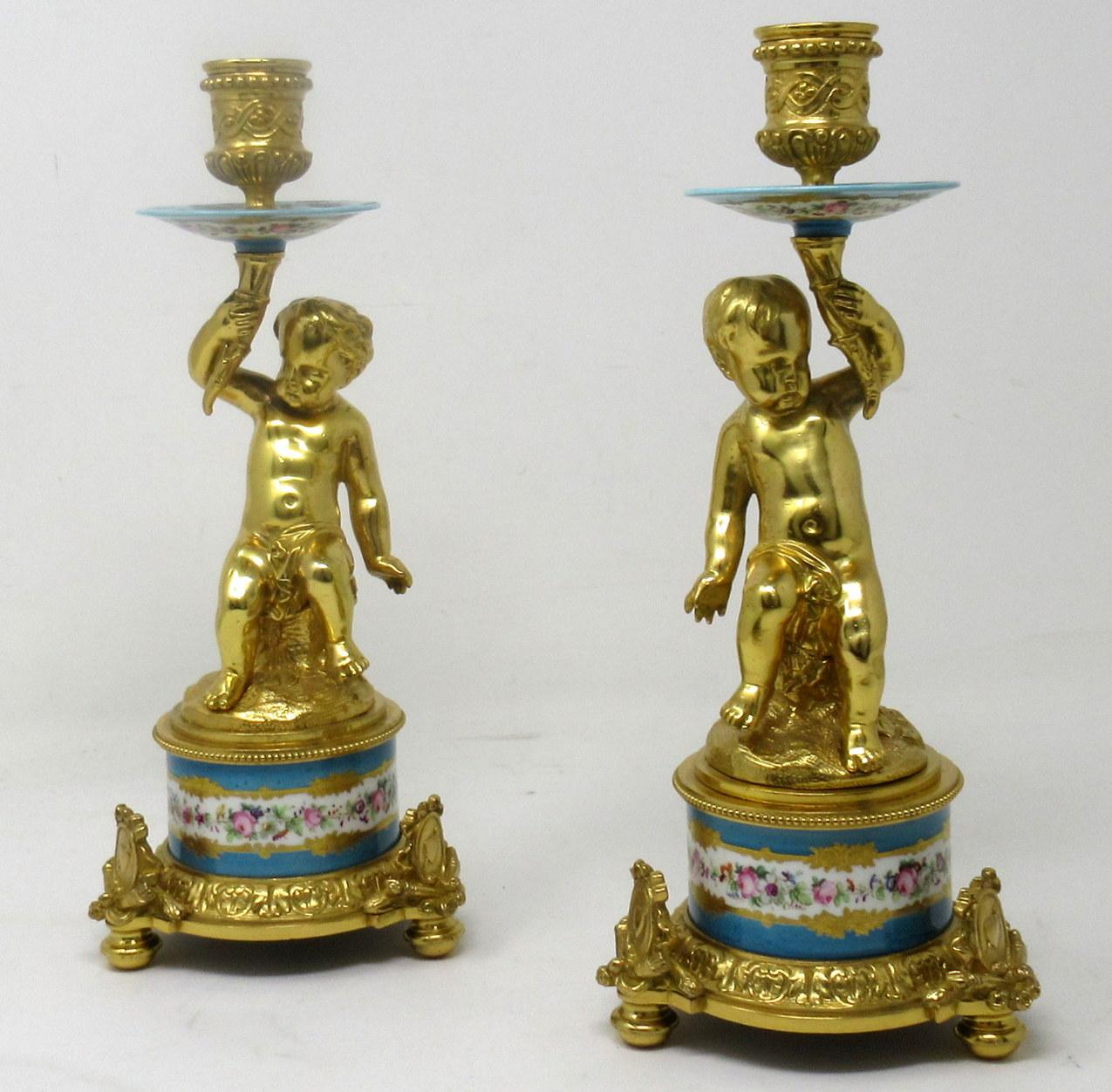 A fine pair of stylish and imposing French ormolu & sevres porcelain heavy gauge single light candlesticks of outstanding quality and of compact proportions. Last half of the nineteenth century. 

Each central support modelled as a Cherub seated