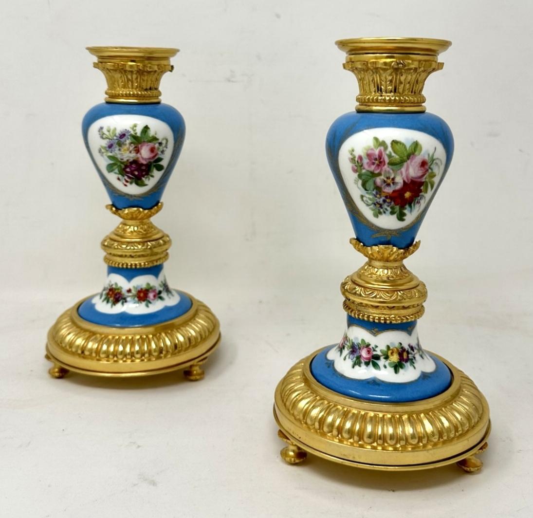 A Fine Pair of Stylish and Imposing French Ormolu & Sevres Porcelain Heavy Gauge Single Light Candlesticks of outstanding quality and of generous proportions. Last half of the Nineteenth Century. 

Each with a central ovoid form porcelain support