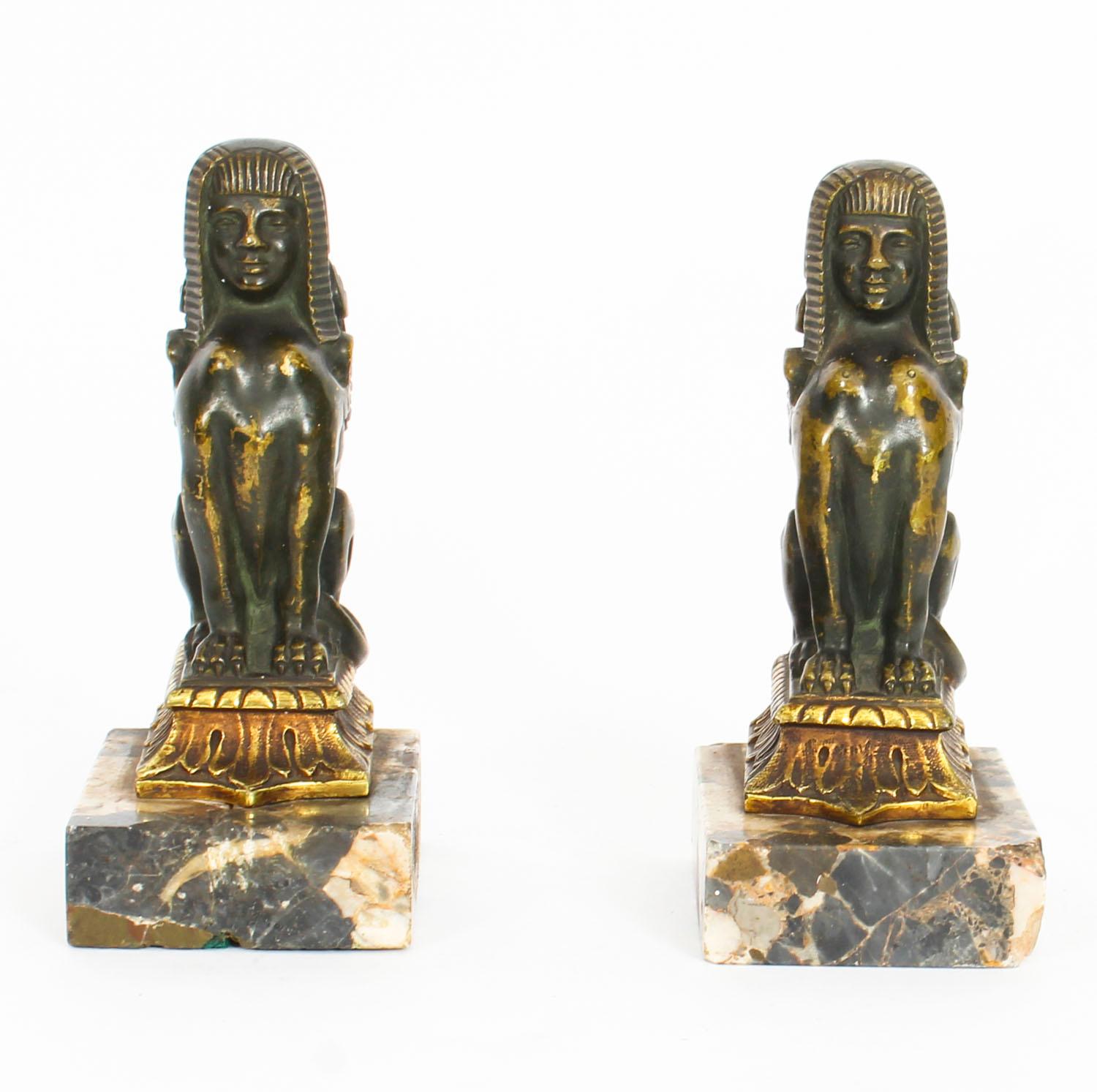 This is a stunning antique pair of 19th century parcel-gilt and dark patinated bronze library bookends, circa 1860 in date.

These exceptionally sculptured bronzes are each cast as a sphinx and set on marble bases.

These high-quality hot cast