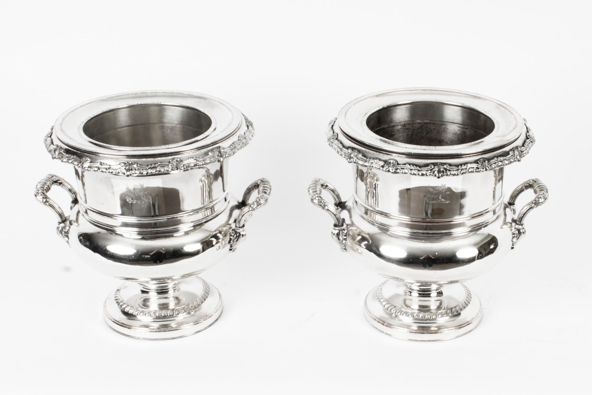 This is an exceptional pair of antique English Old Sheffield Plate silver on copper wine coolers, circa 1815 in date.
 
The wine coolers stand on widespread circular pedestal bases with fluted decoration, the bodies rims and handles are embellished