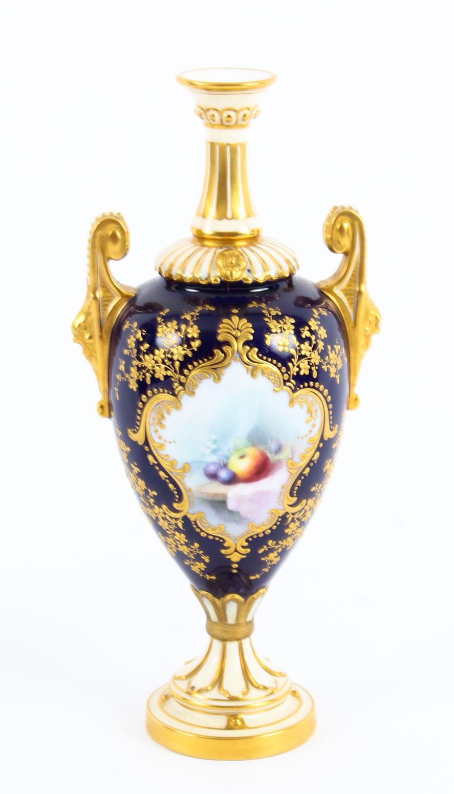 This is a stunning pair of antique Royal Worcester porcelain two handled pedestal ovoid vases bearing the date code for 1903 and shape no. 2269.

The pair features beautiful hand painted apples and plums set within exquisite raised gilt shaped