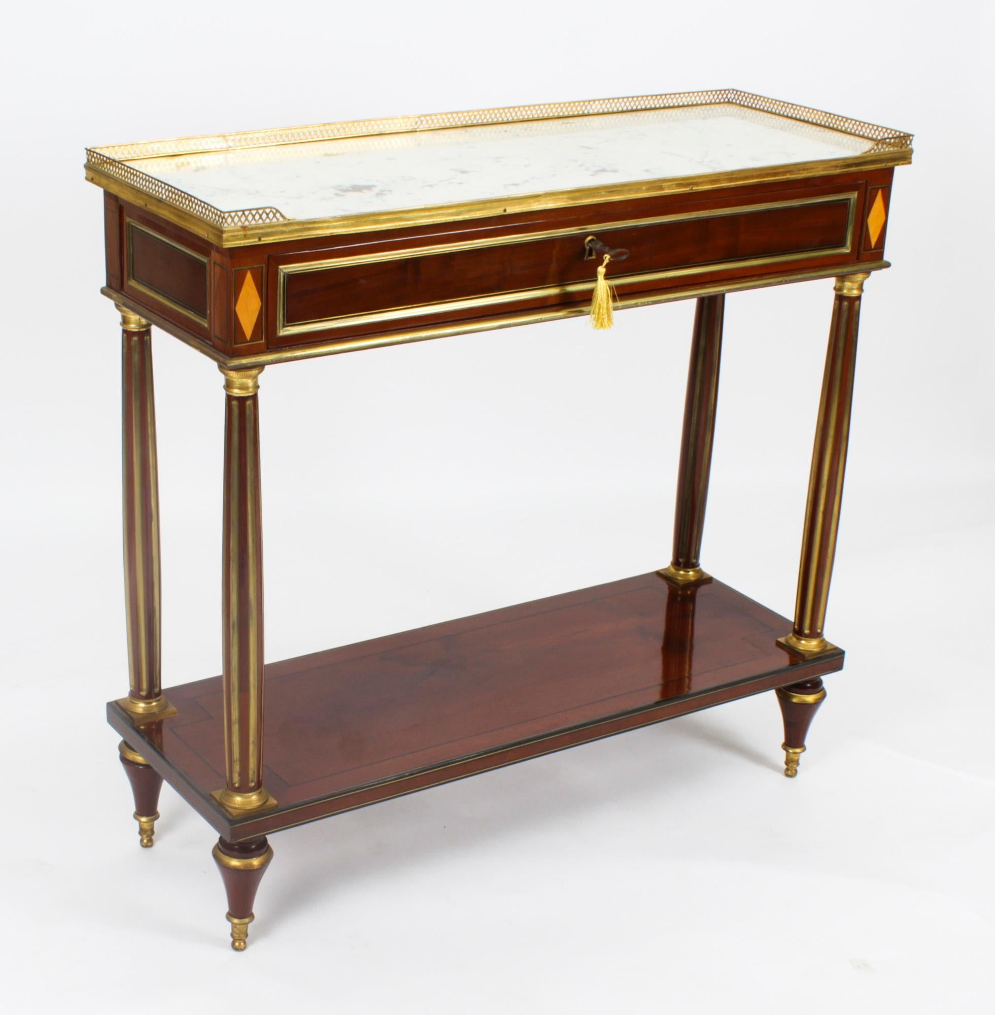 This is a fine antique pair of Russian Neo-classical marble topped and ormolu mounted mahogany console tables, dating from Circa 1840.
 
The Gris St Anne marble tops feature decorative three quarter pieced brass galleries over frieze drawers