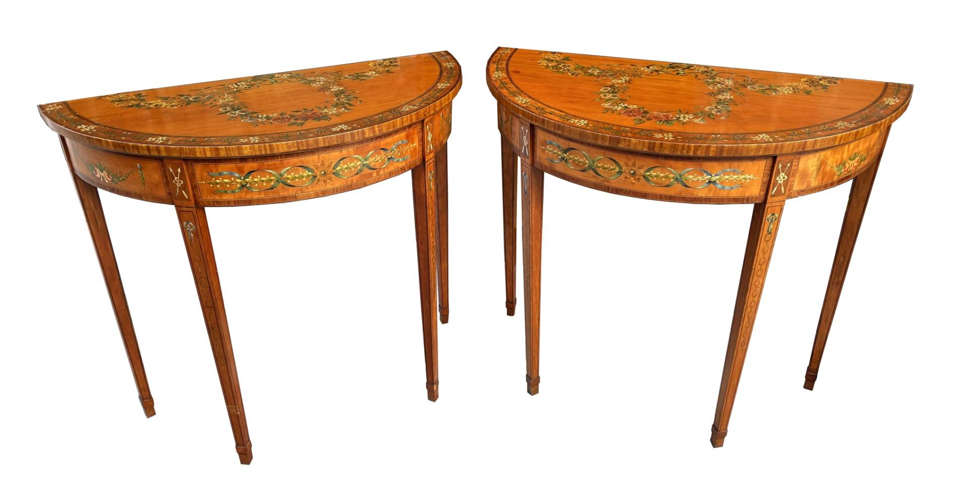 An exceptionally fine example of a Pair of Hand Decorated in colours Inlaid Demi-lune well figured Satinwood Side Tables of compact proportions of English origin, made during the last quarter of the Nineteenth Century. 

Superbly painted with