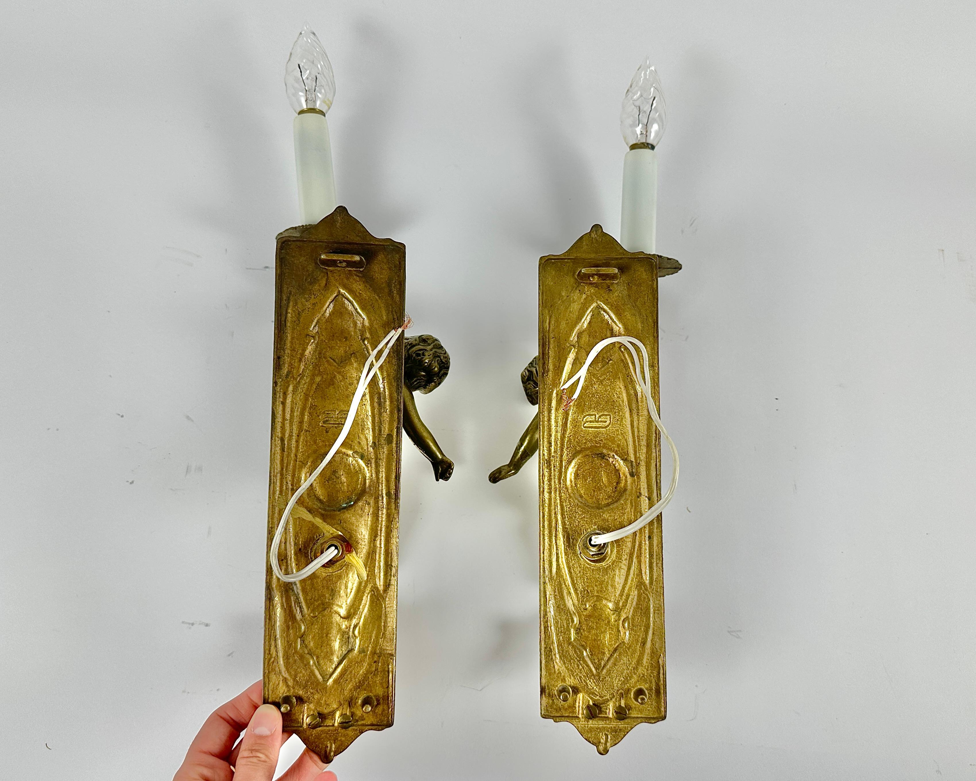Antique pair of extremely decorative cherub wall lights/sconces.

A pair of early 20th century French Art Nouveau period, finely cast and chased bronze wall lights in the shape of 