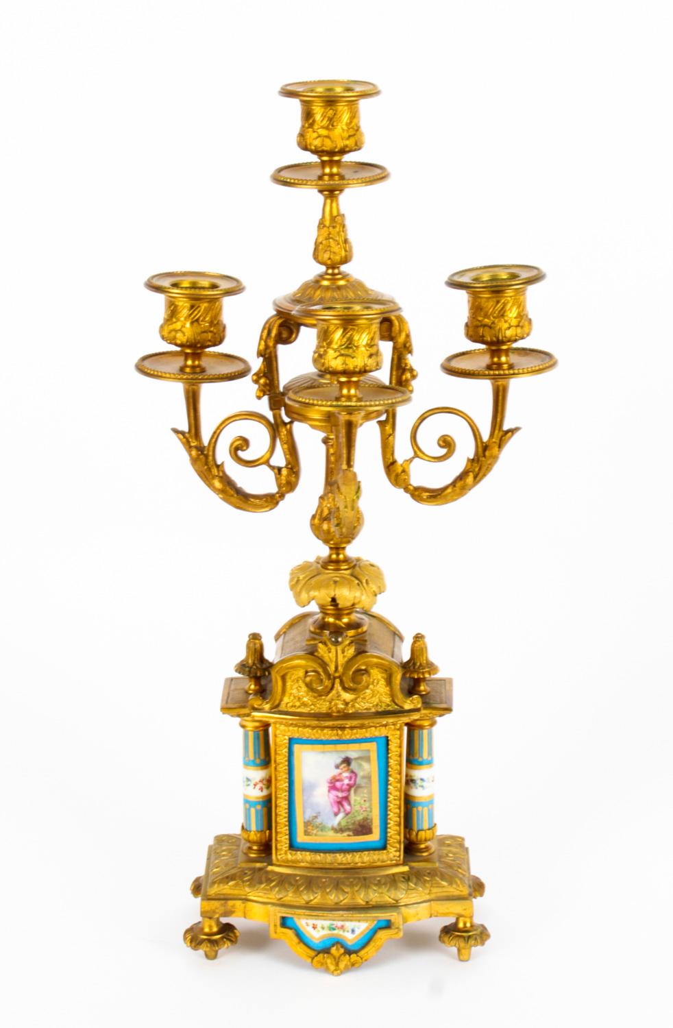 This is a delightful antique pair of Louis Revival ormolu and Sevres porcelain four-branch candelabra, circa 1860 in date.
 
They feature beaded nozzles and drip pans on S-scroll sconces and scrolling acanthus branches.

The inverted baluster