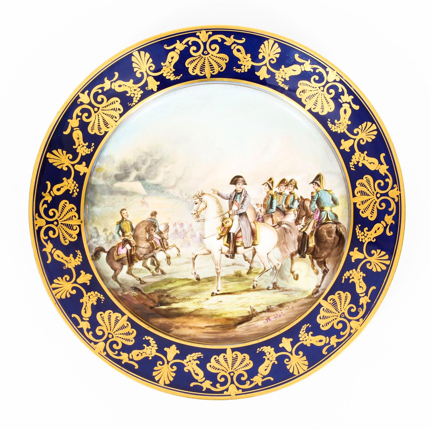 This is an enchanting antique pair of Sevres porcelain cabinet plates, late 19th century in date.

Both are beautifully painted with scenes from the life of Napoleon on the battle field with royal blue borders with classical gilt