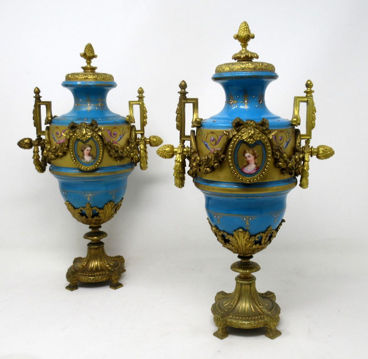 Stunning pair of French Sèvres soft paste hand decorated jeweled porcelain and ormolu table or mantel (fireplace) Urns with unusual decorative suspending husk gilt bronze handles of traditional form and of outstanding quality, made during the last