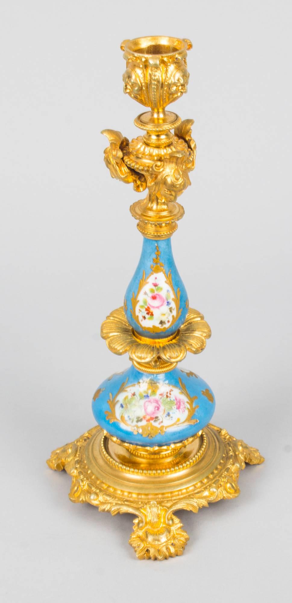 This is a delightful antique pair of 19th century French Sèvres Porcelain mounted ormolu candlesticks.
 
The baluster shaped Sèvres Porcelain columns feature hand painted panels of summer flowers on a bleu celeste ground with gilt highlights. They