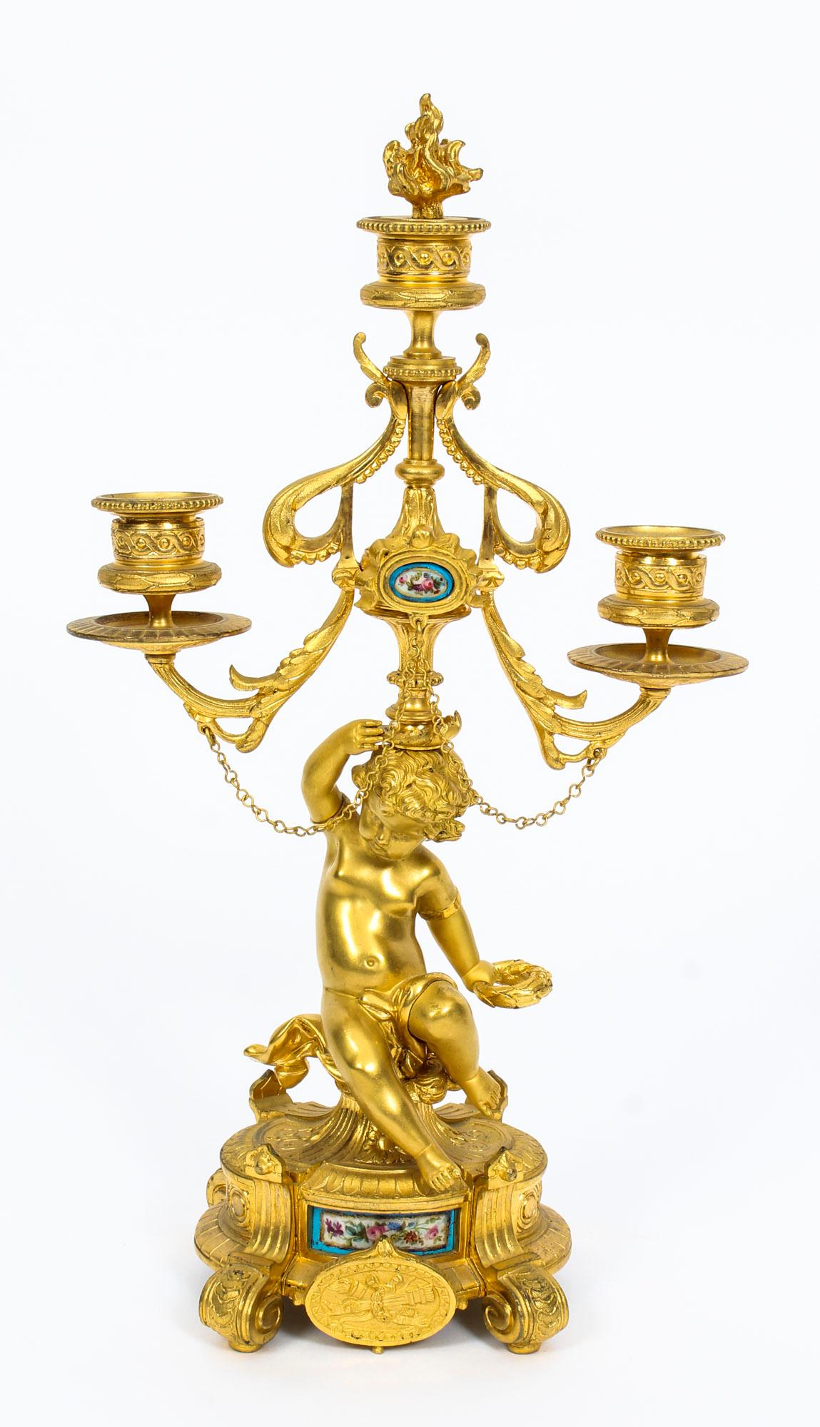 This is a delightful high quality antique pair of Louis Revival ormolu and Sèvres porcelain three-branch candelabra, circa 1860 in date.

The candelabra feature small inset oval floral painted Sèvres porcelain plaques. 

Each has a central