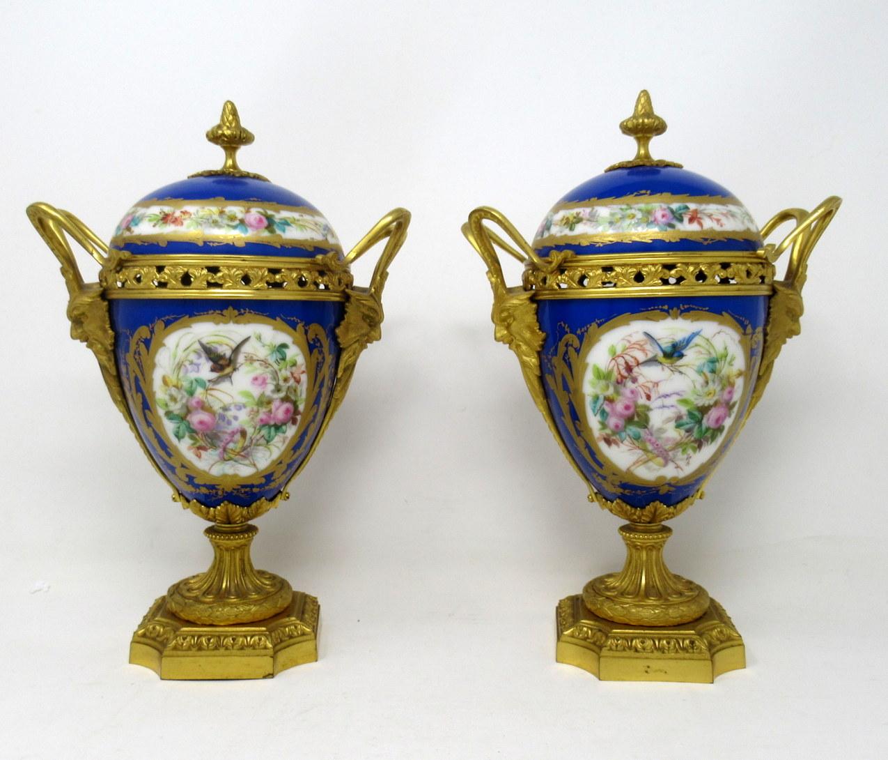 Stunning pair of French Sèvres soft paste porcelain and ormolu twin handle table or mantel (fireplace) urn of traditional bulbous form and of outstanding quality, raised on a square stepped base with canted corners. 

The twin handles exquisitely