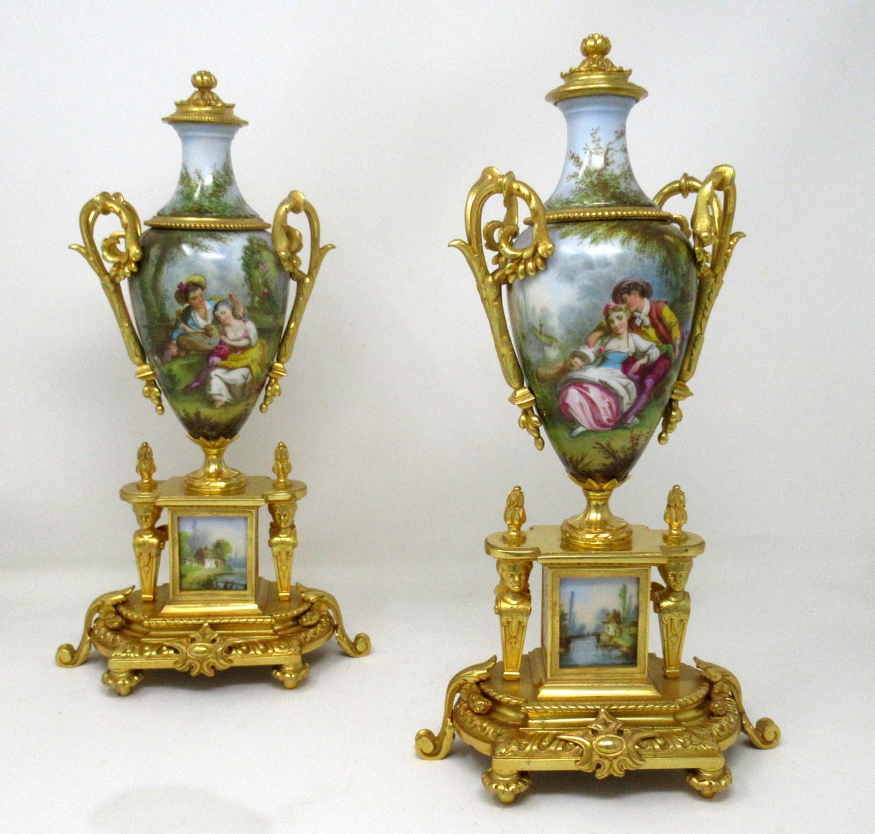 Stunning pair of French Sevres soft paste hand decorated porcelain and Ormolu twin scroll handle table or mantle urns of traditional form and of outstanding quality, made during the last half of the 19th century. 

Each urn of ovoid outline