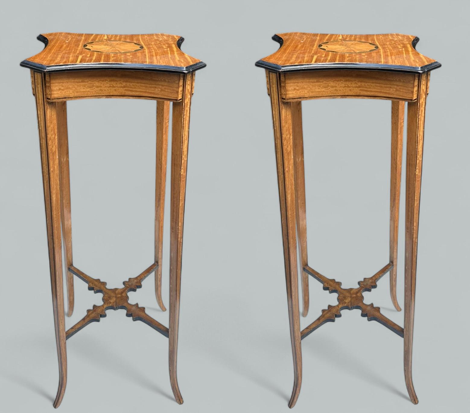 Superb Pair of very elegant Edwardian Sheraton Revival polished Satinwood Wine Tables or Torchers of compact proportion, of English origin. Late Nineteenth, early Twentieth Century. 

With Sycamore Shell inlay and ebonised detail and elegant slender